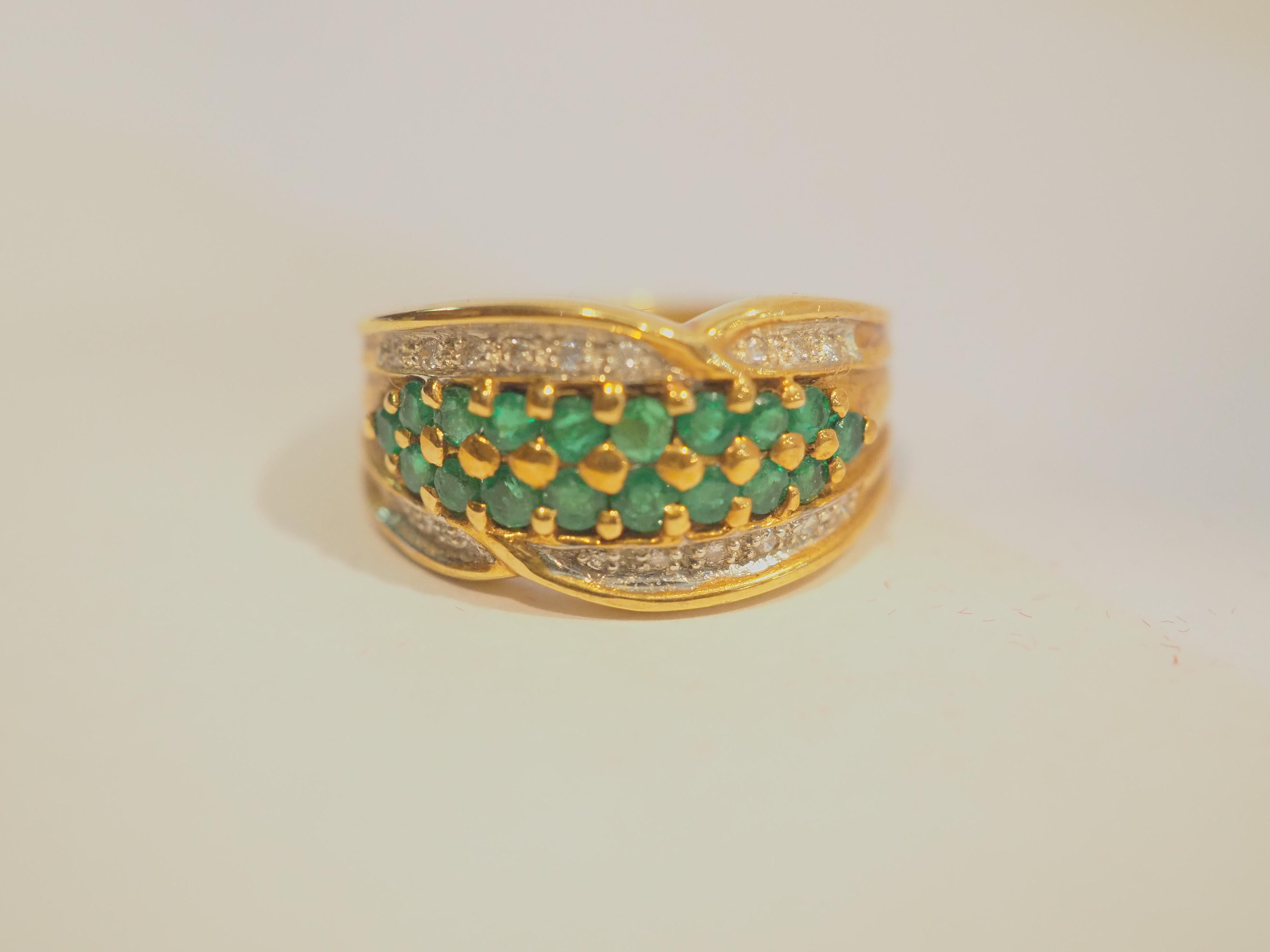 A gorgeous luxury Neo-vintage chunky and fancy band ring that is unworn. This ring is immaculately designed. The round cut emeralds have a beautiful deep green hue, and the round diamonds are very bright and clean. This ring is perfect for fashion
