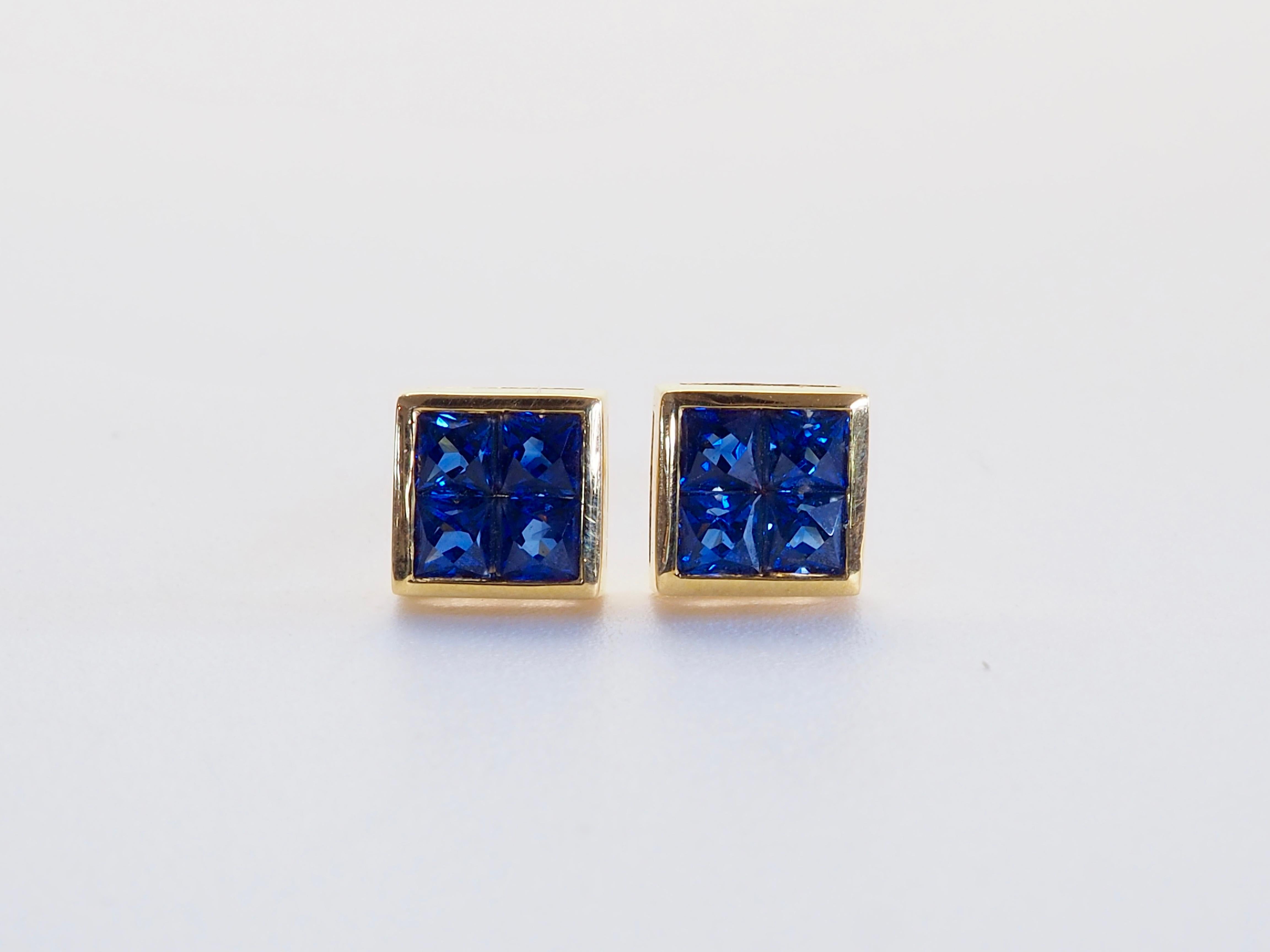 Beautiful and unique earrings made in the 1990's and has never been worn. The earrings have the unique geometric shape with channel design. There are 8 squared and colorfully saturated blue sapphires in total and therefore 4 for each ear. They are