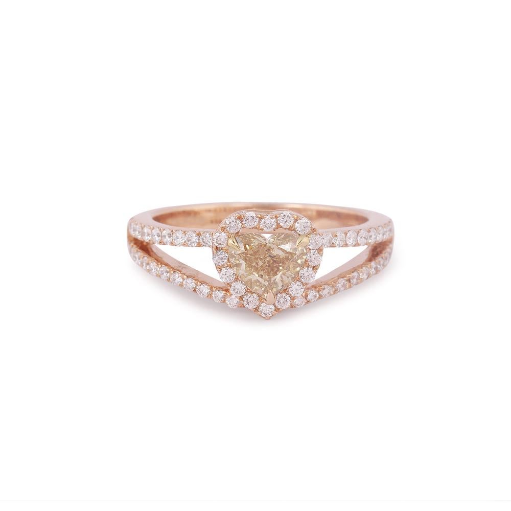 Crafted in 4.47 grams of 18-karat Rose Gold, The Brouha Ring contains 63 Stones of Round Diamonds with a total of 1.19-Carats in F-G Color and VVS-VS Clarity combined 1 Stone of Heart Diamond with a total of 0.70-Carats in Fancy Brown Yellow Color