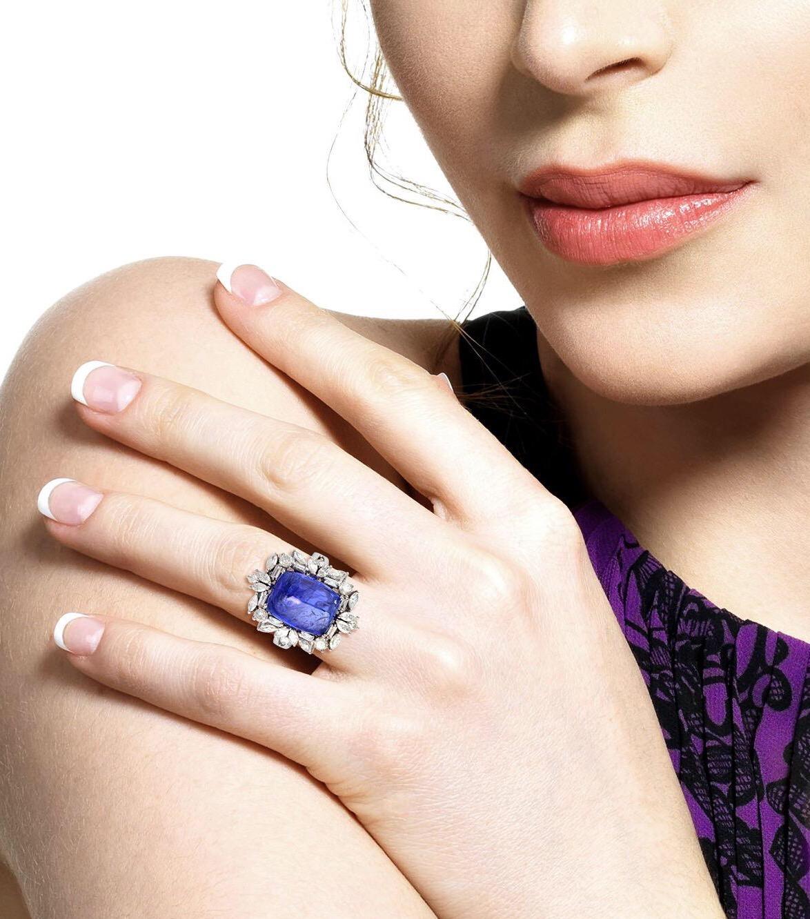 This stunning statement ring has been crafted from 14-karat gold.  It is hand set with 14.0 carats tanzanite and 1.92 carats of glimmering diamonds. 

The ring is a size 7 and may be resized to larger or smaller upon request. 
FOLLOW  MEGHNA JEWELS
