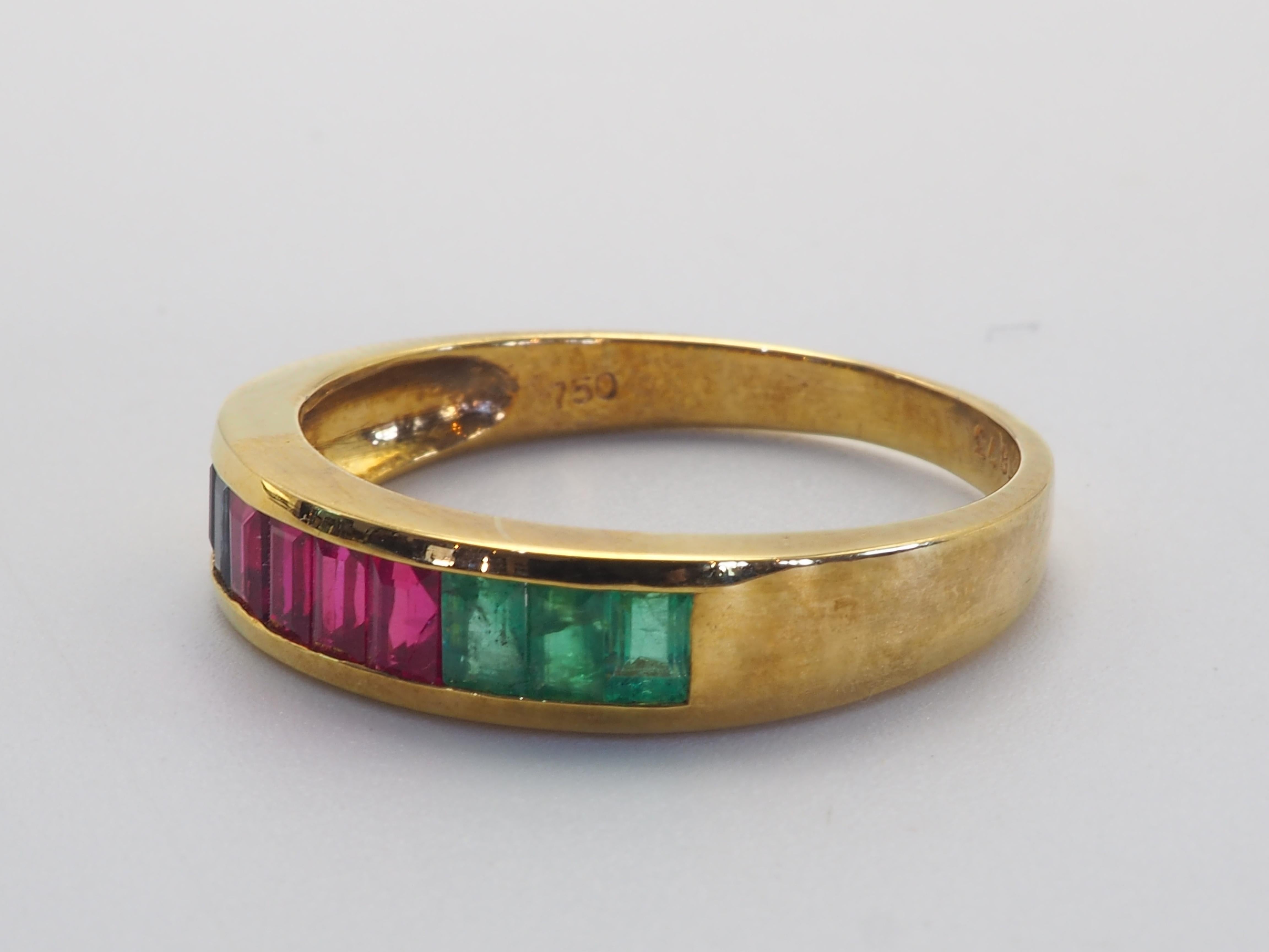 Un precioso y lujoso anillo de banda neo-vintage apto para ambos sexos. Este anillo tiene hermosos colores muy saturados de 3 esmeraldas verdes en baguette, 3 zafiros azules en baguette y 4 rubíes rojos vivos en baguette, y están muy bien