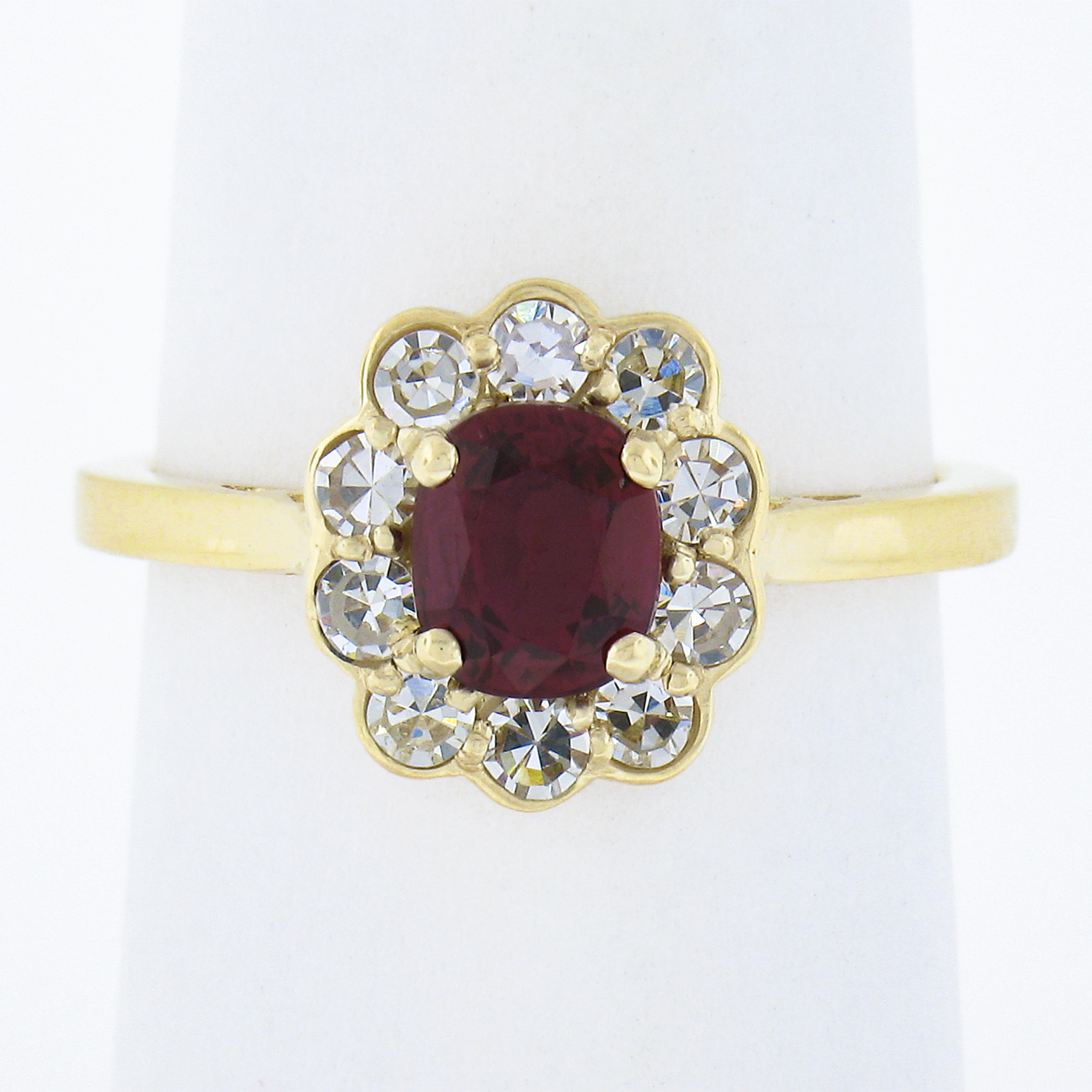 This adorable custom made ruby and diamond flower ring is well crafted in solid 18k yellow gold. The elegant flower cluster design is set with a GIA certified, natural ruby stone that displays truly mesmerizing, vivid, super fine red color and has