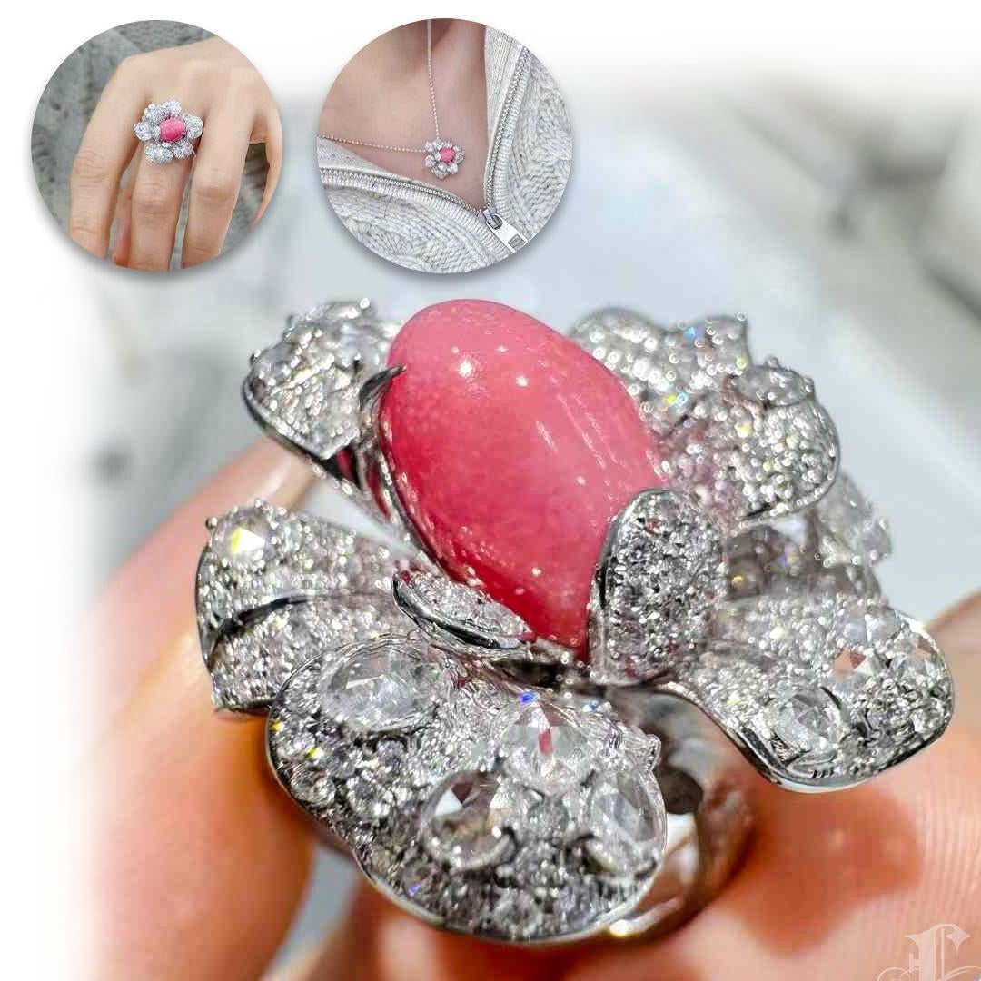 Anmutig zwischen Kunst und Natur balancierend, besticht dieses meisterhaft gestaltete Cabrio-Schmuckstück durch eine 4,15-karätige natürliche Muschelperle in einem intensiven Flamingo-Rosa, über deren gewölbte Oberfläche lebhafte Flammenmuster