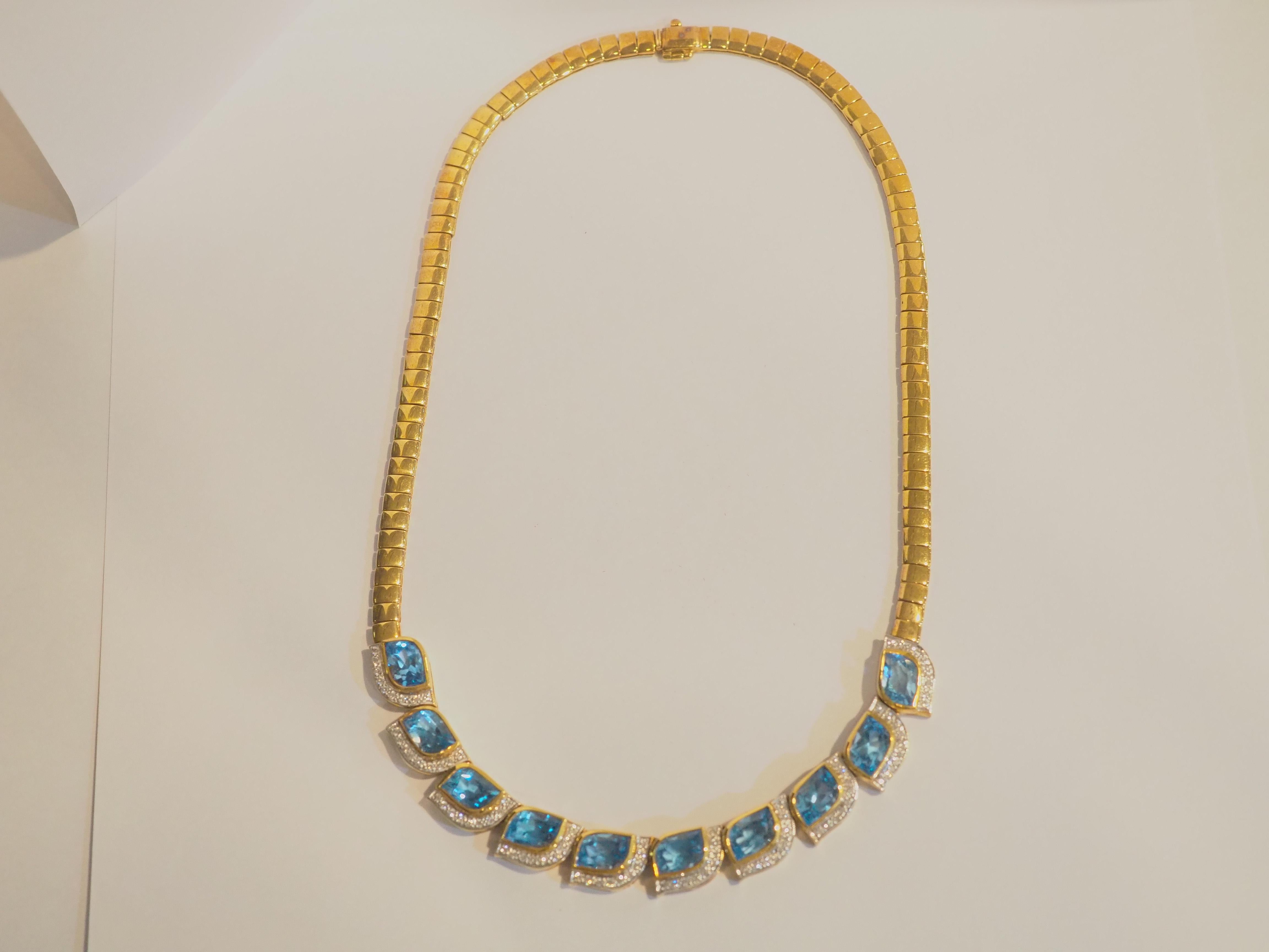 This wonderful piece is a neo- vintage and has never been worn. This beautiful piece is crafted in Thailand using 18K solid yellow gold. The piece is adorned with 10 gorgeous natural mix cut blue topaz and various 90 pave of good quality round pave