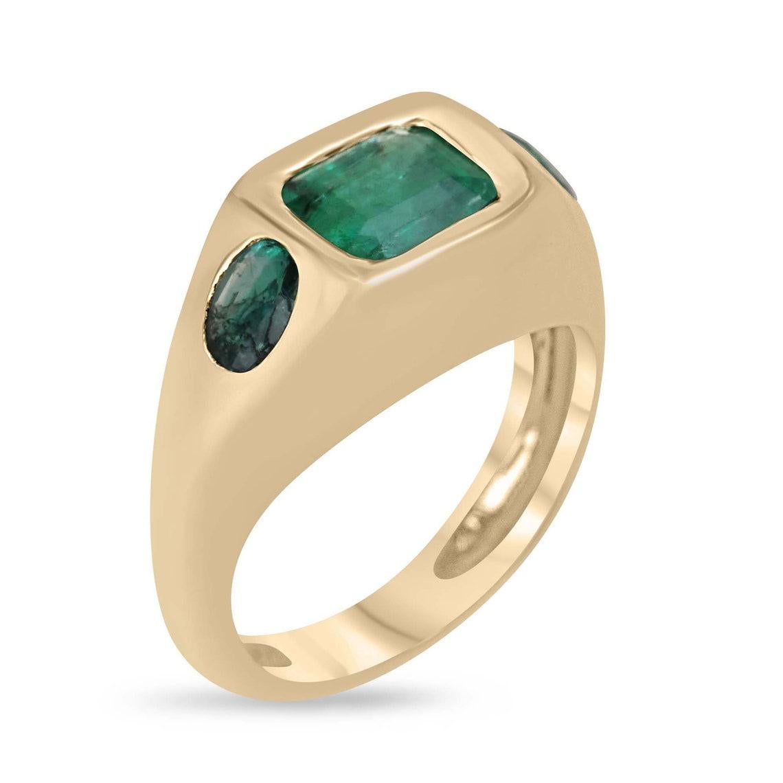 Elevate your style with our striking Emerald Trilogy Ring, a true symbol of elegance and versatility. Featuring three stunning Zambian emeralds, the center stone is an emerald-cut emerald set east to west, while the side stones boast captivating