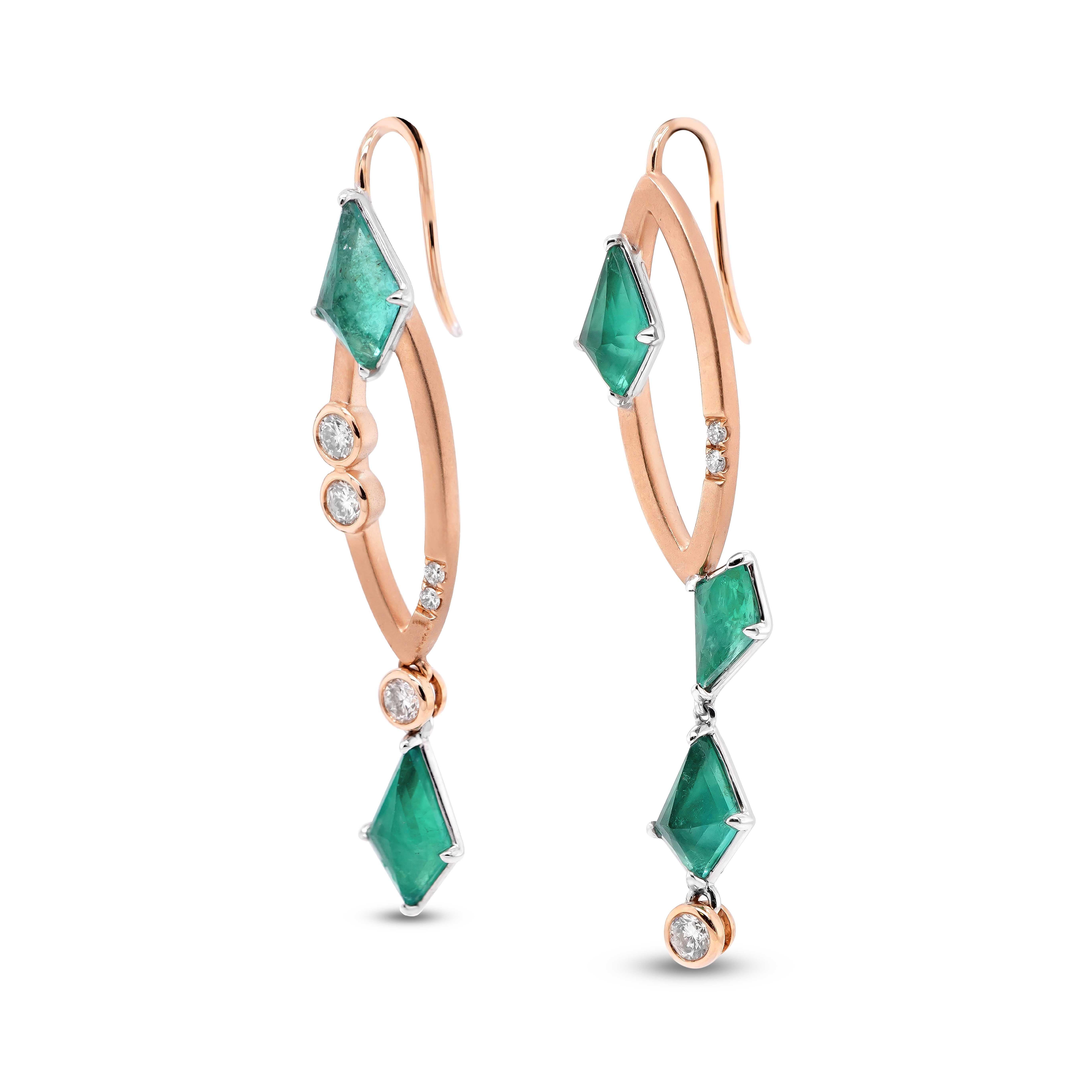 A pair of asymmetrical earrings comprising of kite shaped emeralds and white diamonds. A total of 3.35 carat of elegant long cut kite shaped emerald are set with 0.44 carat of white brilliant round diamond.
These green hued gemstones are formed due