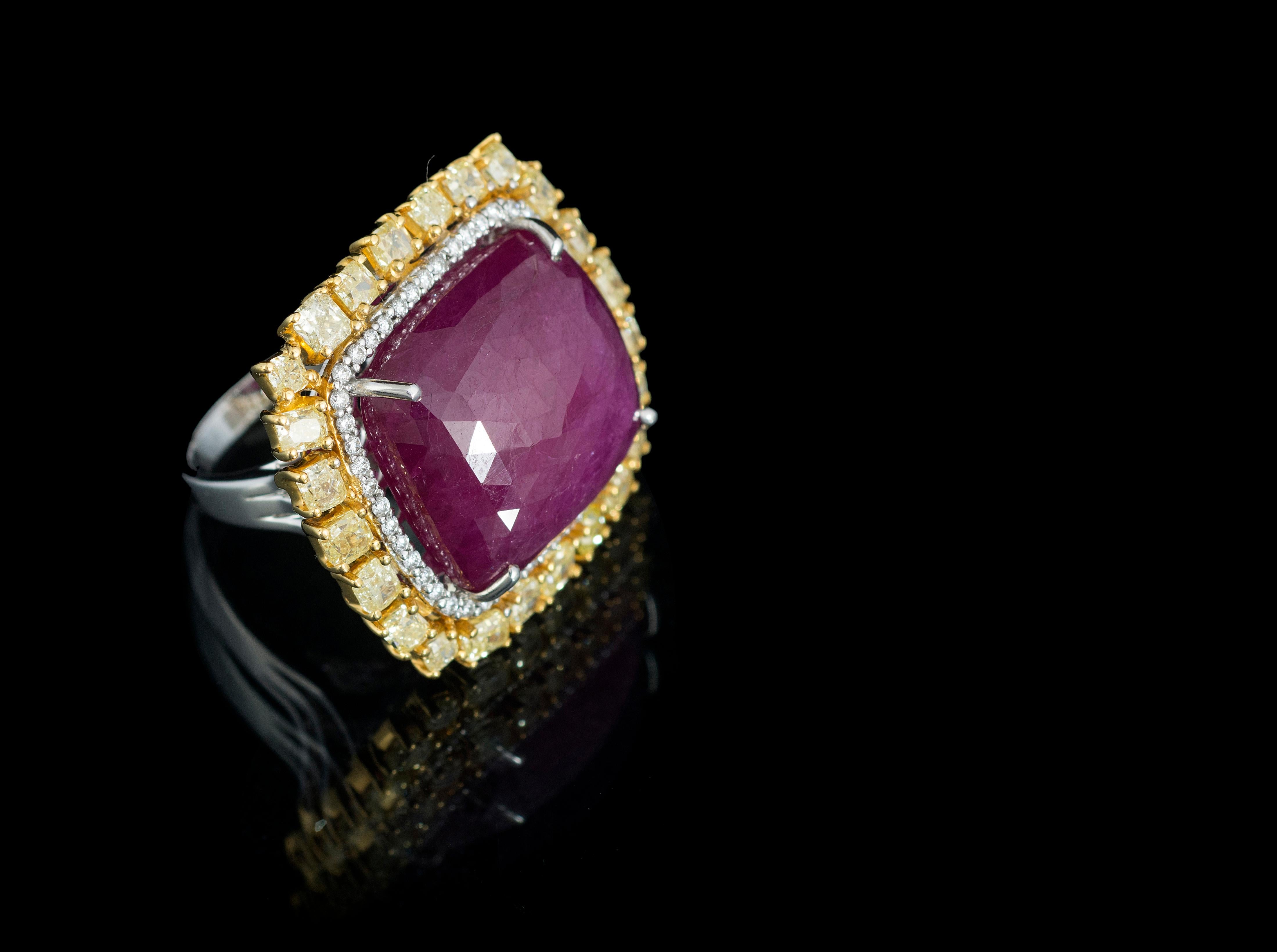 A very gorgeous and attractive cocktail ring set in 18K white gold with Ruby and Yellow Diamonds. The weight of the faceted Ruby 34.82 carats. The Ruby is completely natural, without any treatment and is of Mozambique origin. The combined weight of