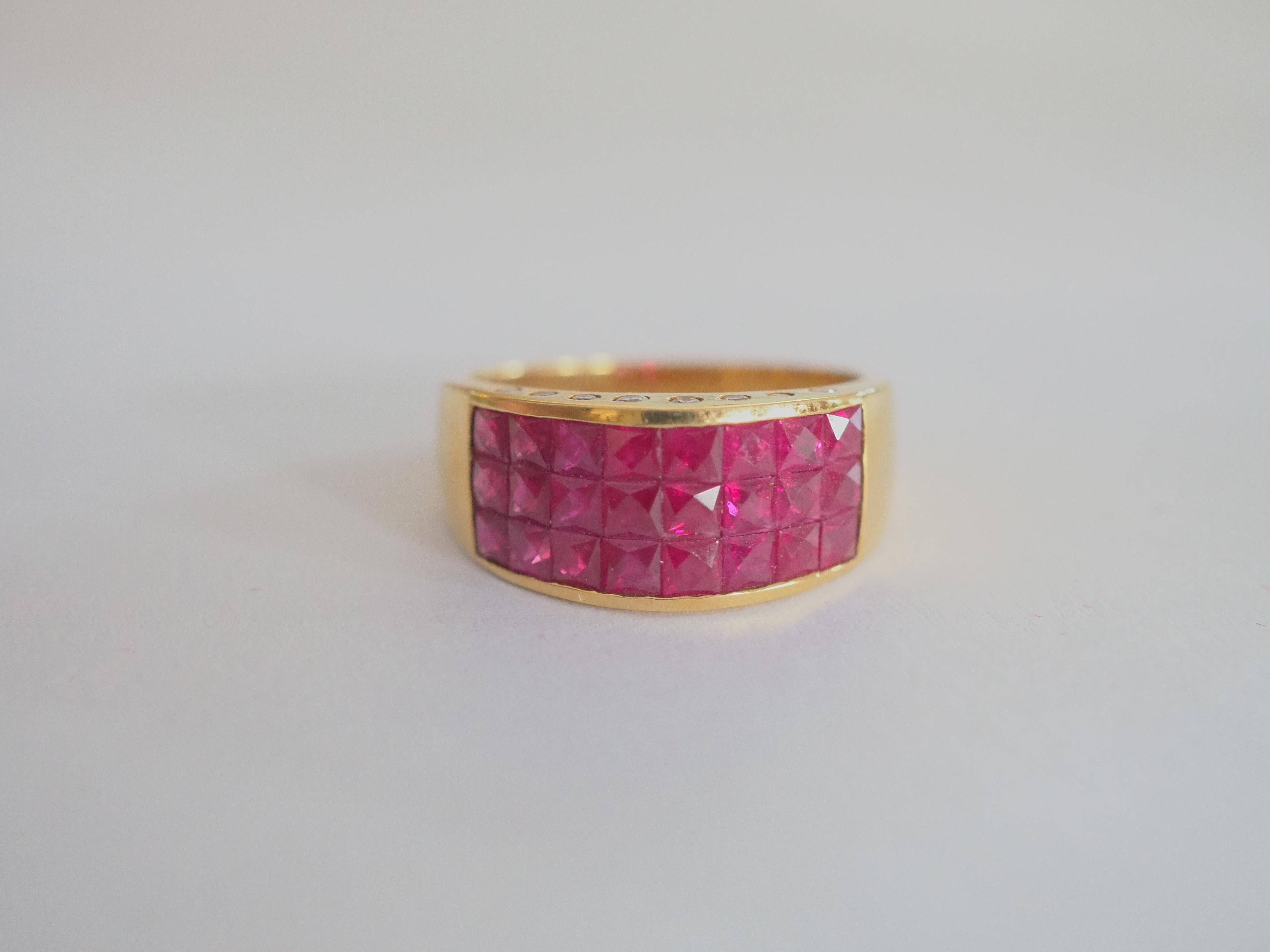 A gorgeous luxury Neo-vintage chunky invincible style band ring that is both suitable for all sexes. This ring has three rows of beautiful Thai rubies and pave round diamonds channeled nicely into the band. The square cut rubies have a beautiful