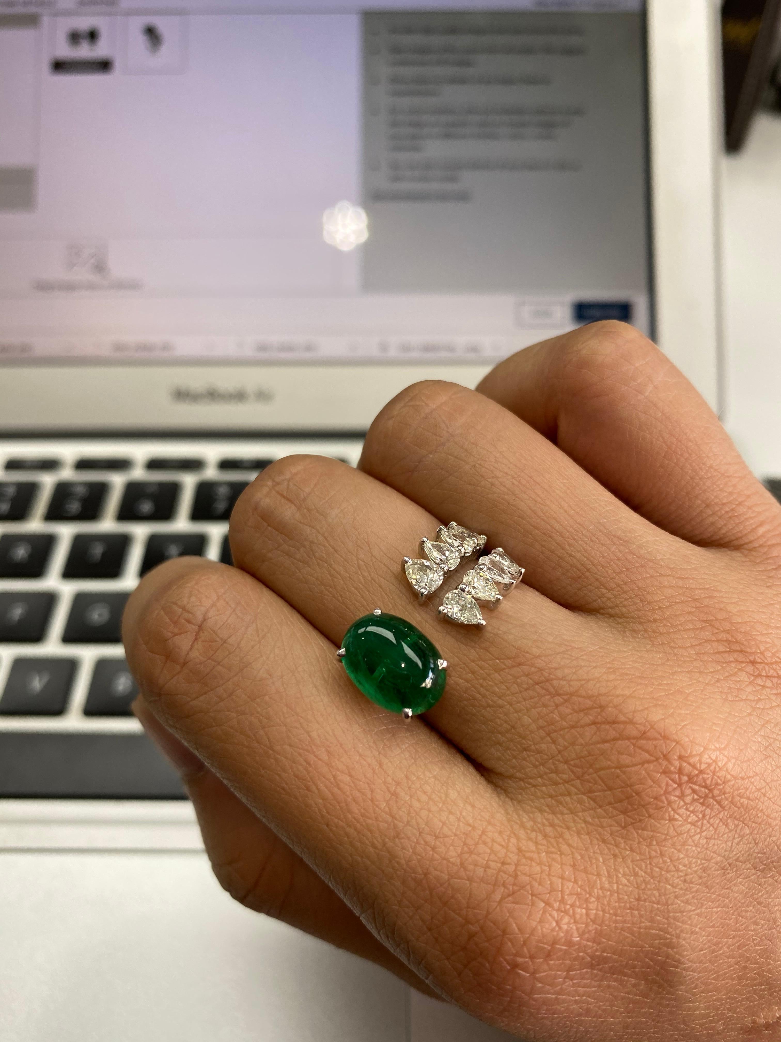A beautiful Zambian Cabochon Emerald & Pear Shaped Diamonds Cocktail Ring set in 18K White Gold. The weight of the Zambian Cabochon is 4.30 carats and the Emerald is without any treatment or enhancements. The weight of the Diamonds is 1.27 carats.