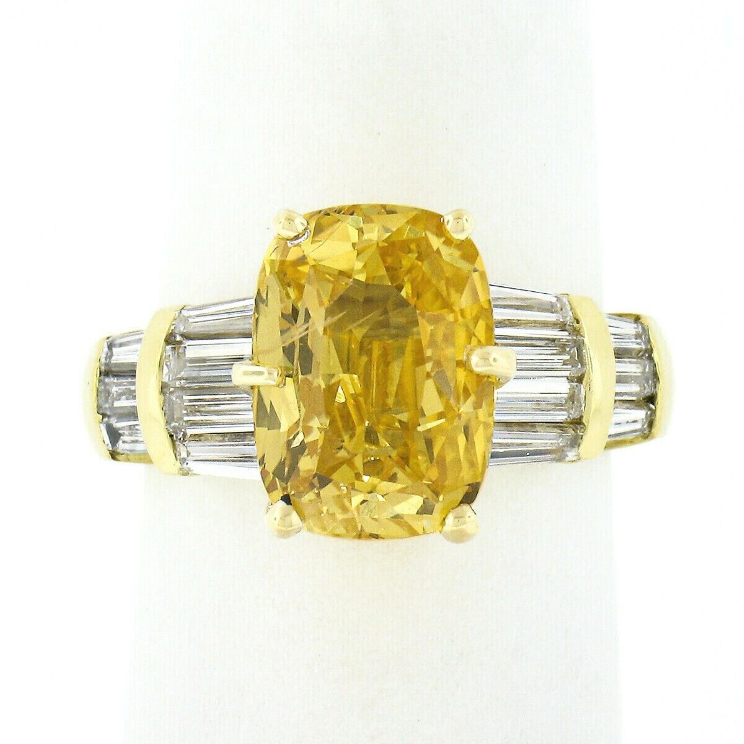 Here we have a truly magnificent yellow sapphire and diamond engagement ring crafted from solid 18k yellow gold. The ring features a natural, GIA certified, cushion cut yellow sapphire that weighs exactly 4.51 carats and is perfectly 6-prong set at