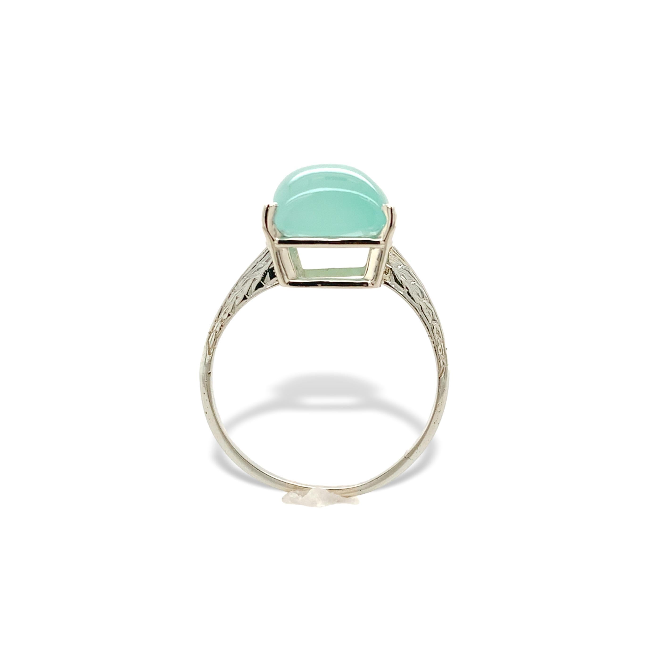 18K white gold 5.73 carat aquaprase ring. The rectangular cabochon cut chalcedony is a light greenish-blue color and measures about 11.5mm x 9.2mm. This piece fits a size 7.5 and weighs 1.93dwt. This is a vintage ring with a new head and new