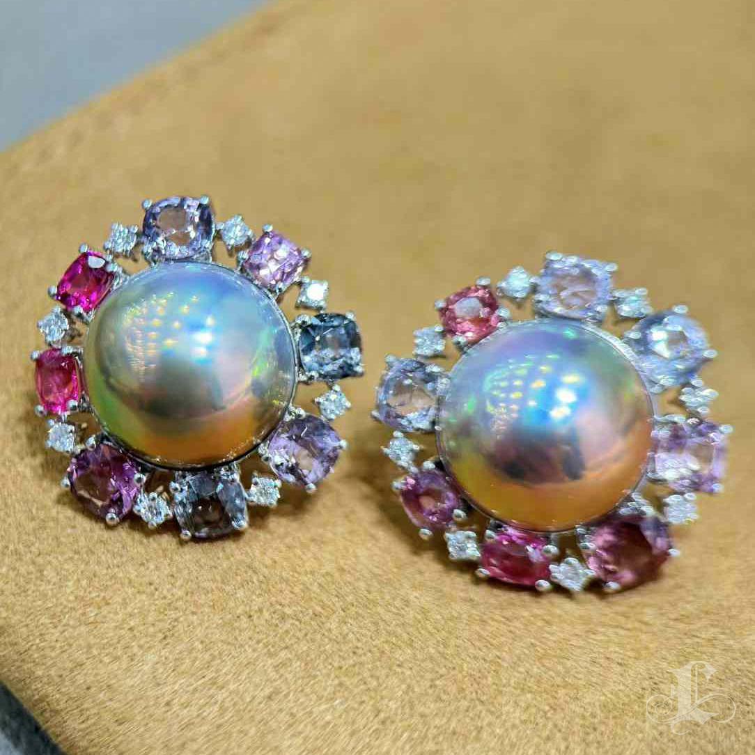Radiating with color and light, these earrings feature a pair of luminous Aurora-grade Mabe pearls encircled by a vivid halo of natural spinels and brilliant-cut diamonds. The floral-inspired composition bursts with shades of blush, violet, and