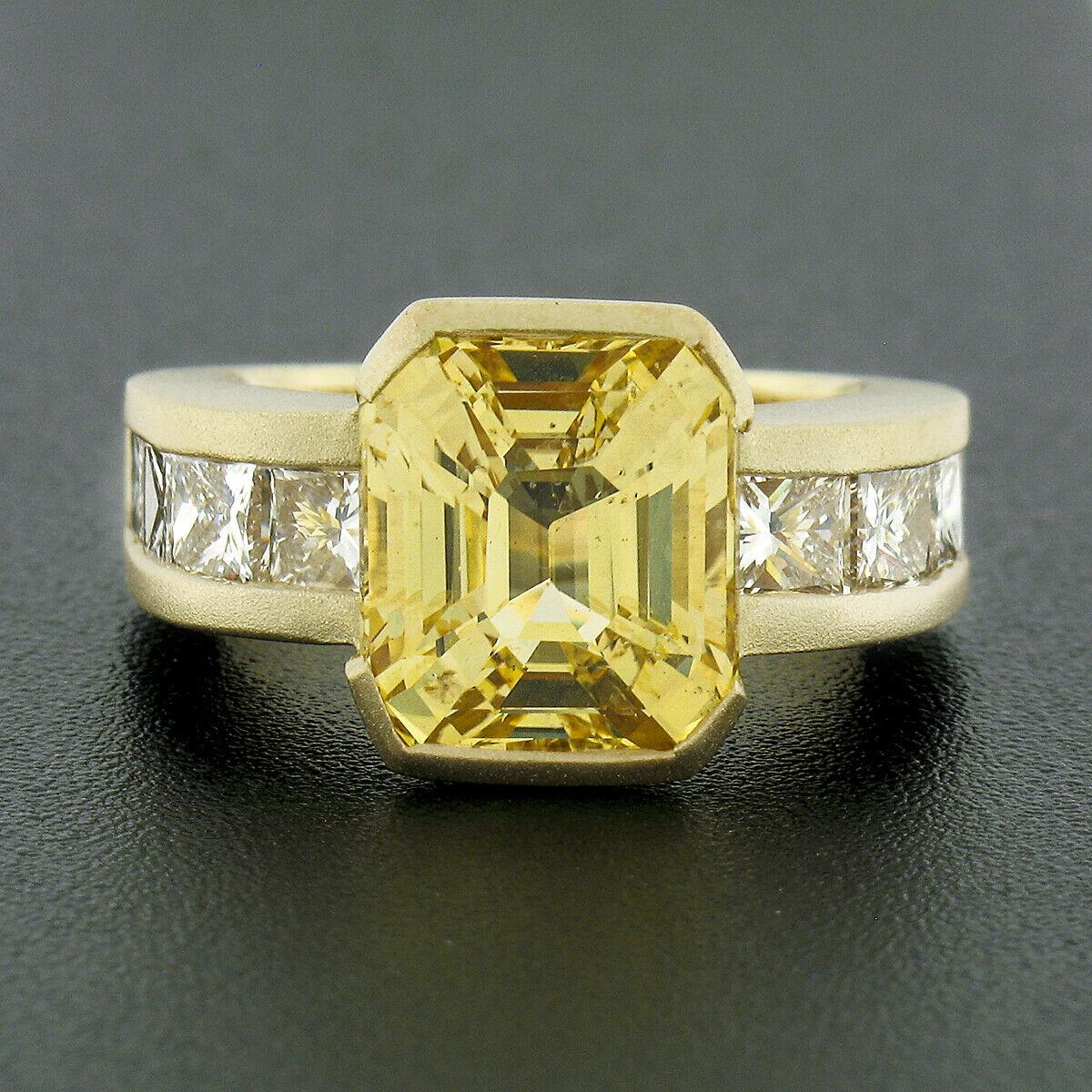 This fancy and unusual yellow sapphire and diamond engagement ring is very well and solidly crafted in solid 18k yellow gold. It features a natural, AGL certified, emerald cut yellow sapphire that weighs exactly 6.04 carats and is perfectly