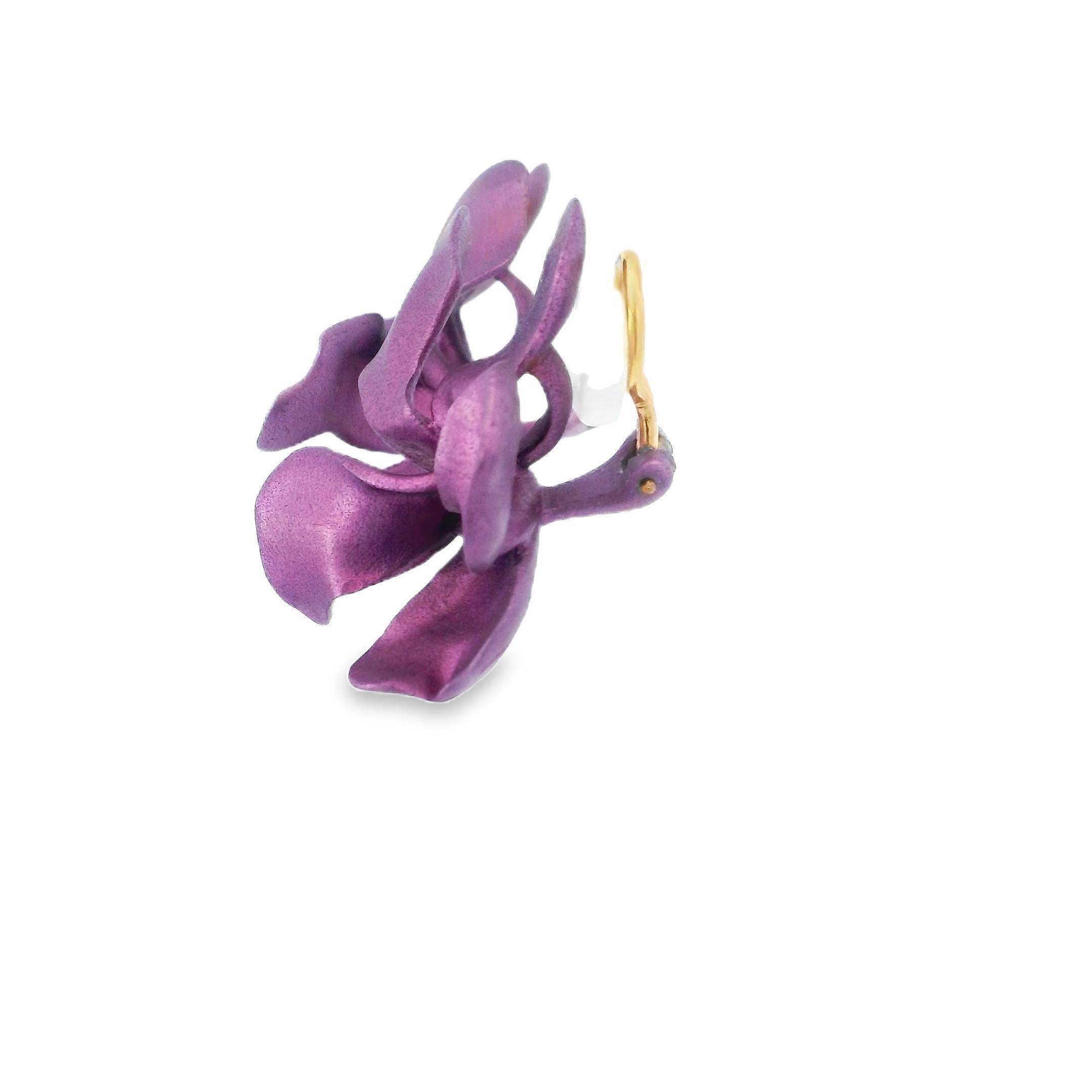 Questi accattivanti orecchini presentano un moderno design floreale realizzato in alluminio con una vibrante tonalità viola. I petali, dalla forma elegante, creano una forma dinamica e organica. La sottile lucentezza dell'alluminio contrasta