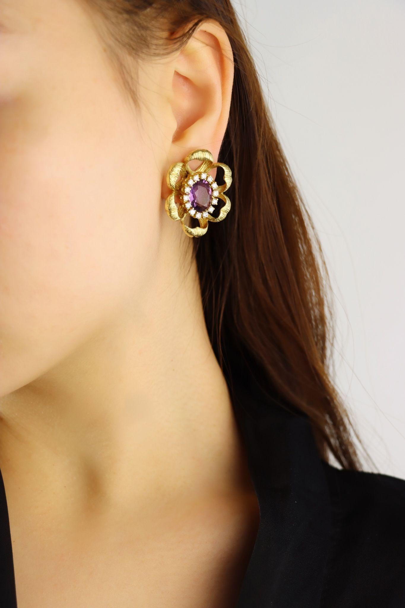 18K Gold Amethyst Diamond Flower Earrings

Approximate Dimensions:
3.5 cm (Length)
3 cm (Width)
Approx. 6.3 ct (Amethyst)
Approx 2 ct (Diamond)
28.0 grams in weight.

** All dimensions listed above are approximations based on our measurements and
