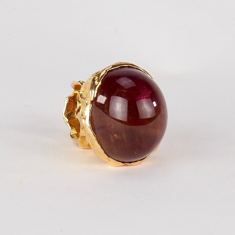 A stunning Italian 18K Gold and Amethyst Cabochon Cocktail Ring 
Of freeform design in the shape of a sculptural nugget this ring has a deep textured finish to the gold which in turn supports a large, impressive domed polished amethyst