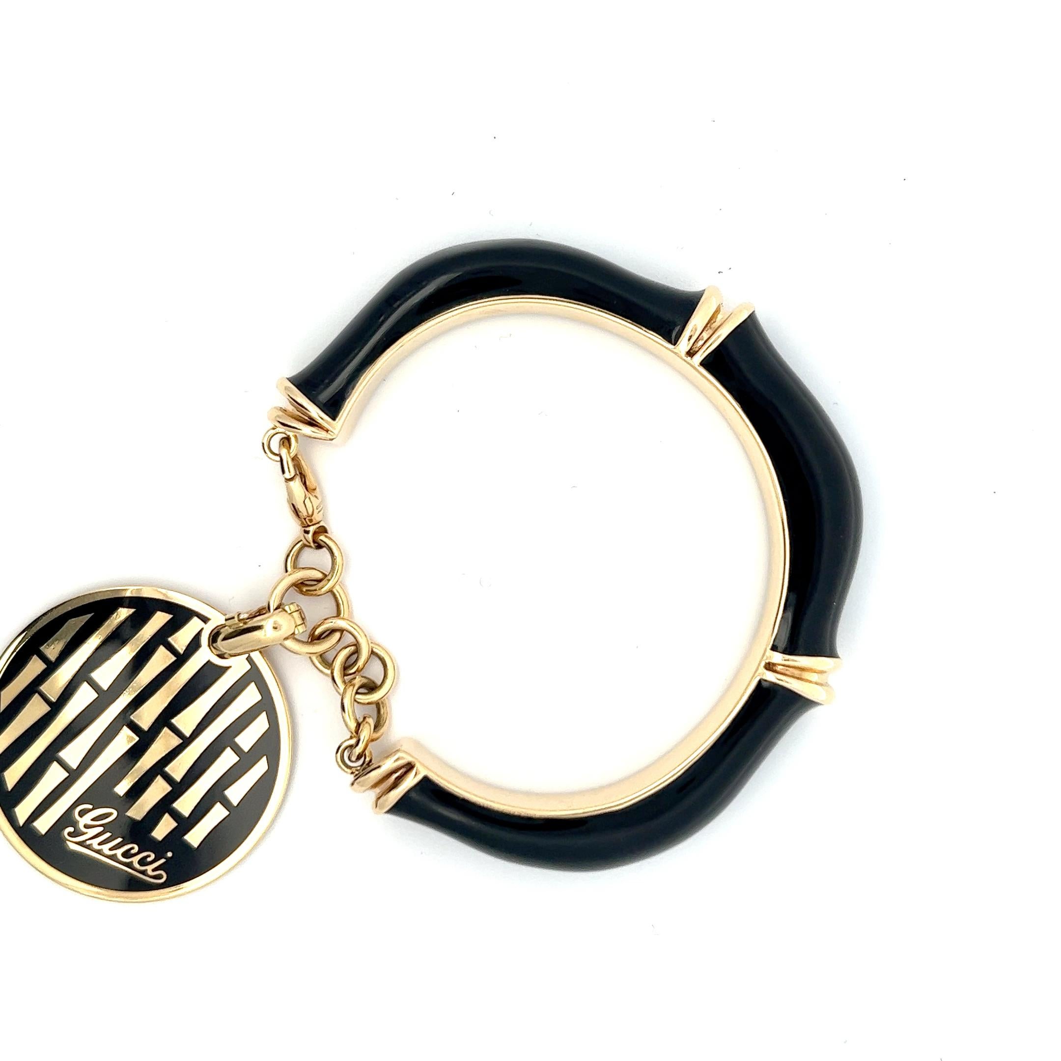 A 18k yellow gold and black enamel bracelet by Gucci.
Made in Florence, Italy, circa 1980.
Size 18.
Marked with the Italian hallmark for 18k gold and an Italian makers for Florence. 
Signed: Gucci. 
Stamped with 18 and Made in Italy.
The round