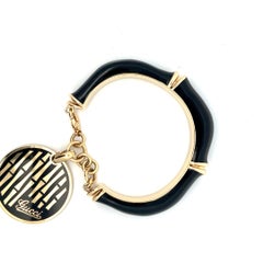 18k gold and black enamel bracelet by Gucci.
