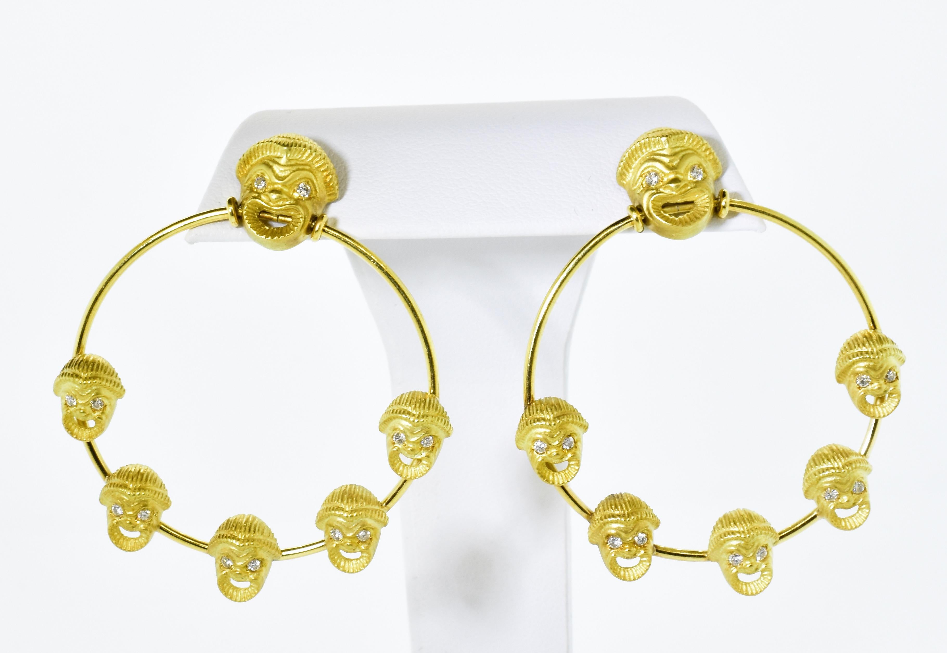 Each of these comedy mask hoop style earrings has 6 masks and each mask is set with diamond eyes - adding an interest to each face.  In all, the diamonds weigh .48 cts.  These diamonds are all brilliant-cut, G/H in color, and very slightly included