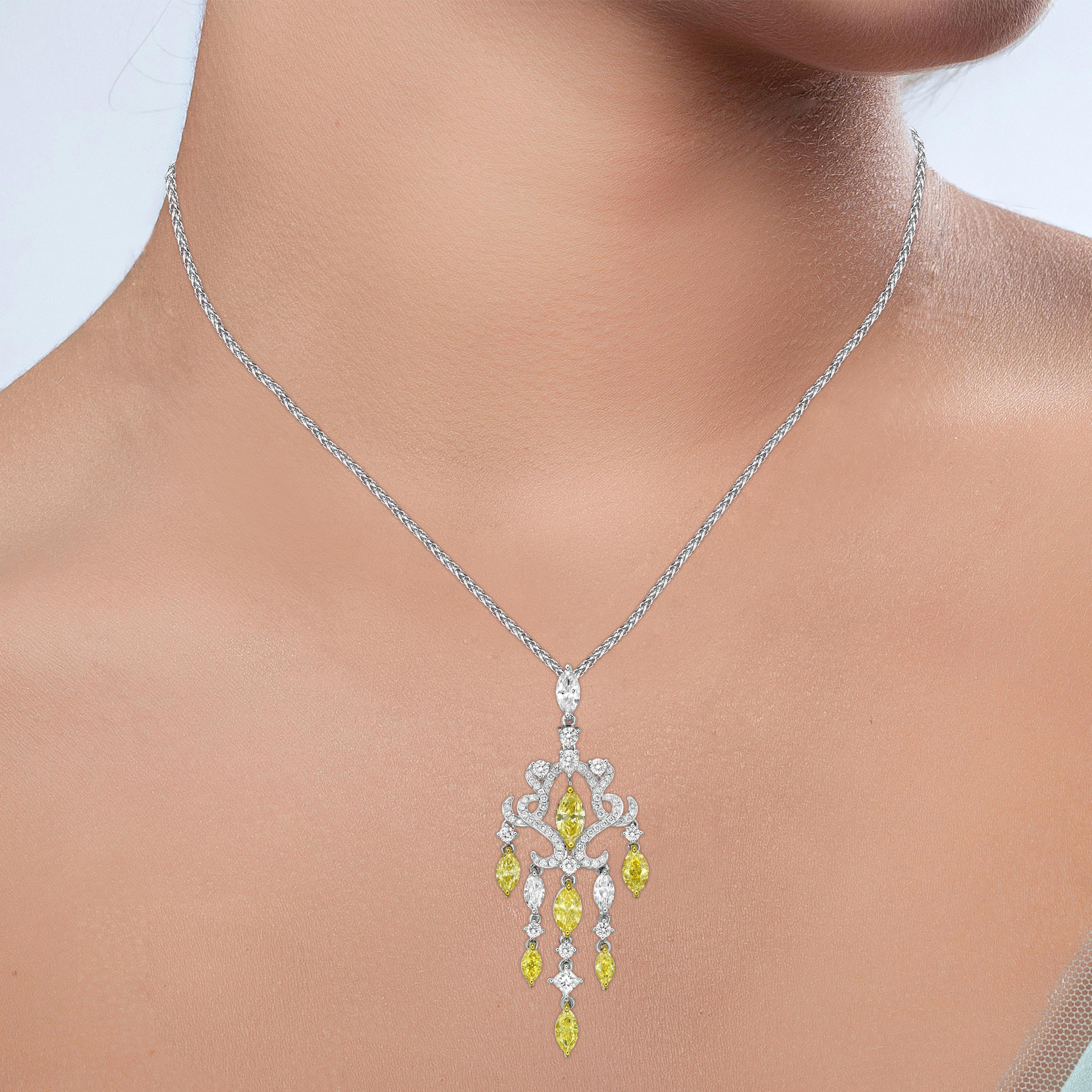 These fascinating Pendant is made in luxurious 18K white gold, featuring Yellow and White Diamonds in Marquise cut in Chandelier design.  Very elegant design.

Yellow and White diamonds give a big contrast on the pieces. 

The white diamonds used in