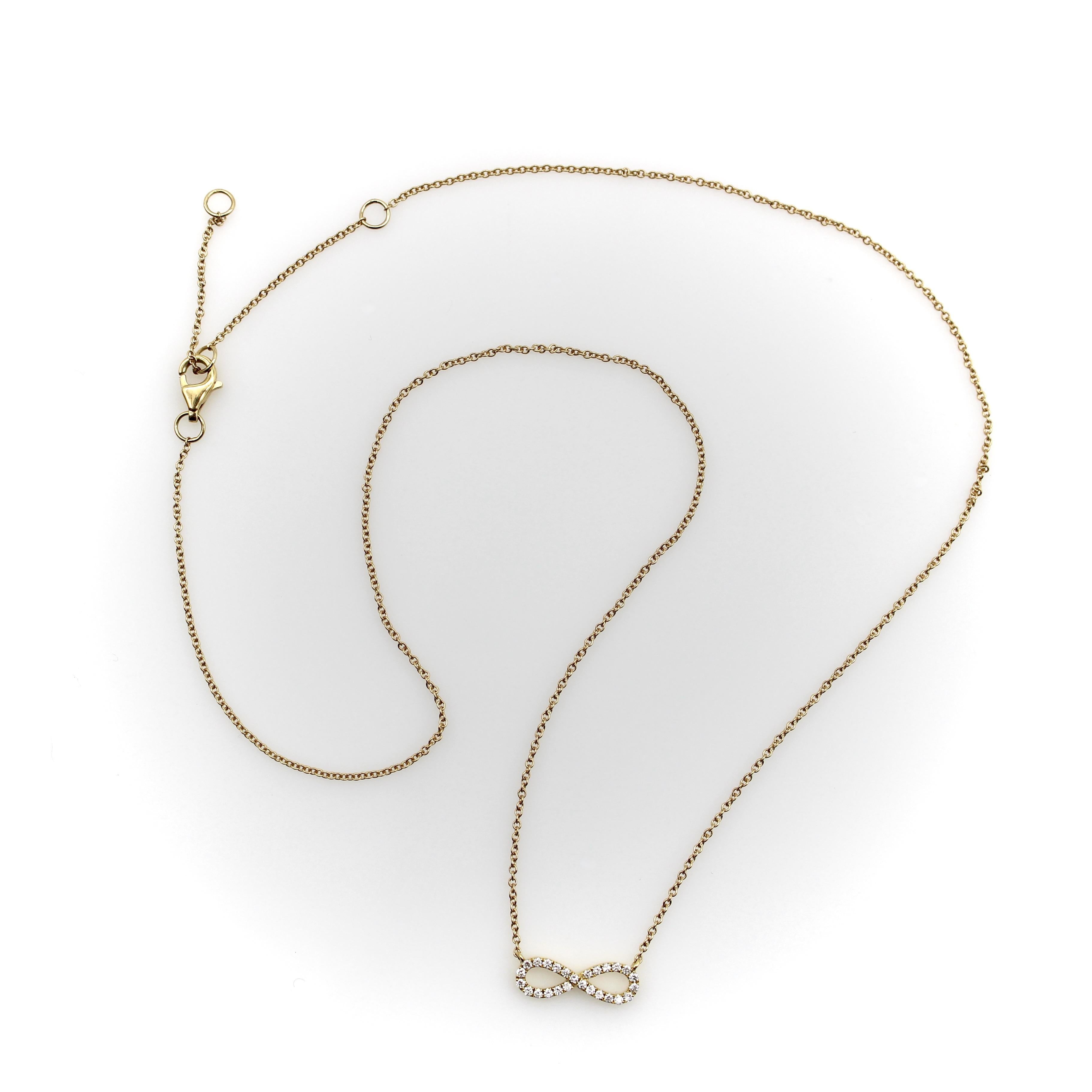 The infinity loop, or figure 8, can represent unending love or eternal spirituality. The loop is encrusted with bright white diamonds, graceful and feminine. The bright diamonds pop against the skin. The infinity loop hangs from a delicate chain