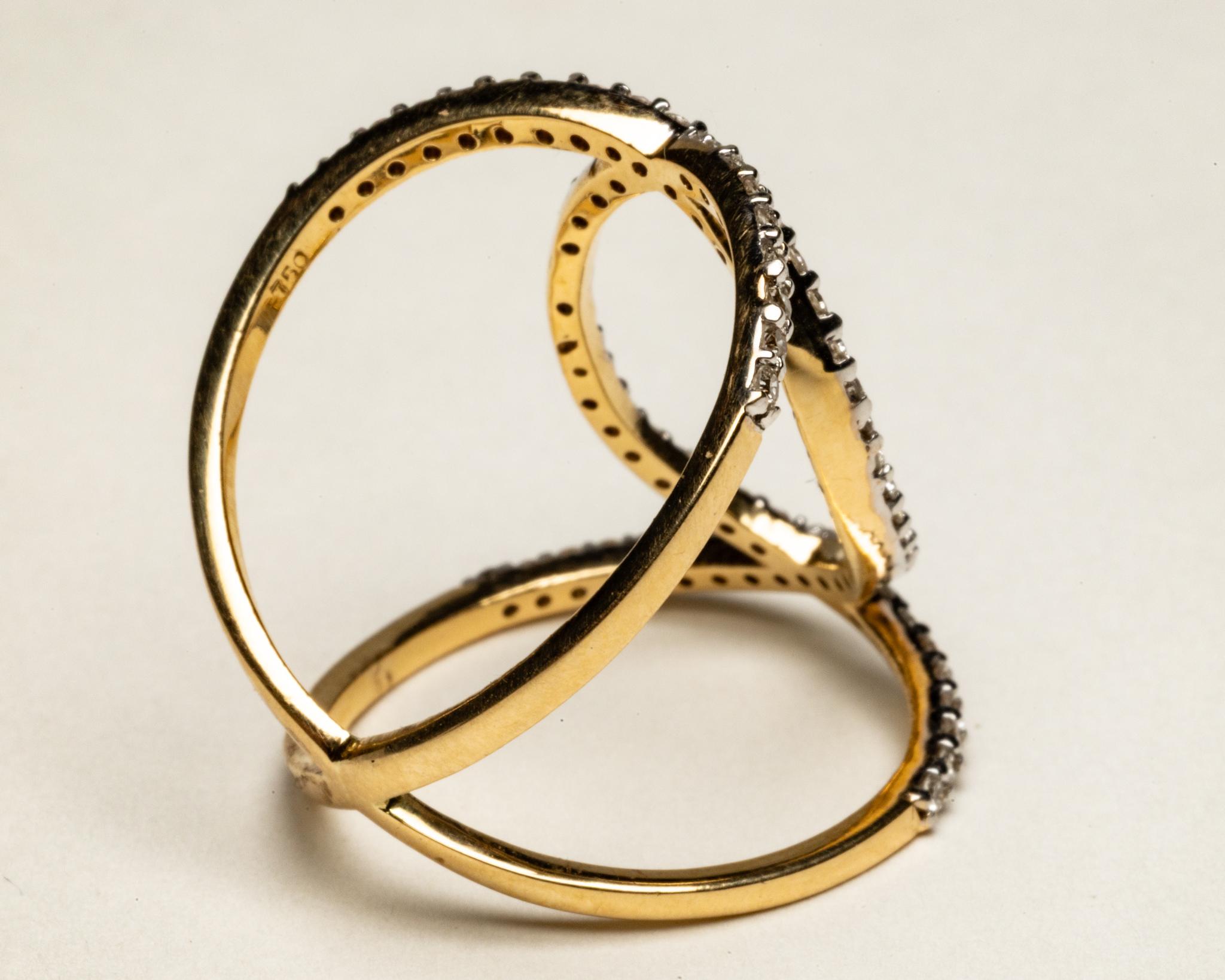 A classic and elegant diamond and 18K gold ring with an interlocking C design.  Round, brilliant cut diamonds in a pave` setting.  Ring size is 6.25.  Carat weight of diamonds is .63.

The fine jewelry collection is sourced, designed or created by