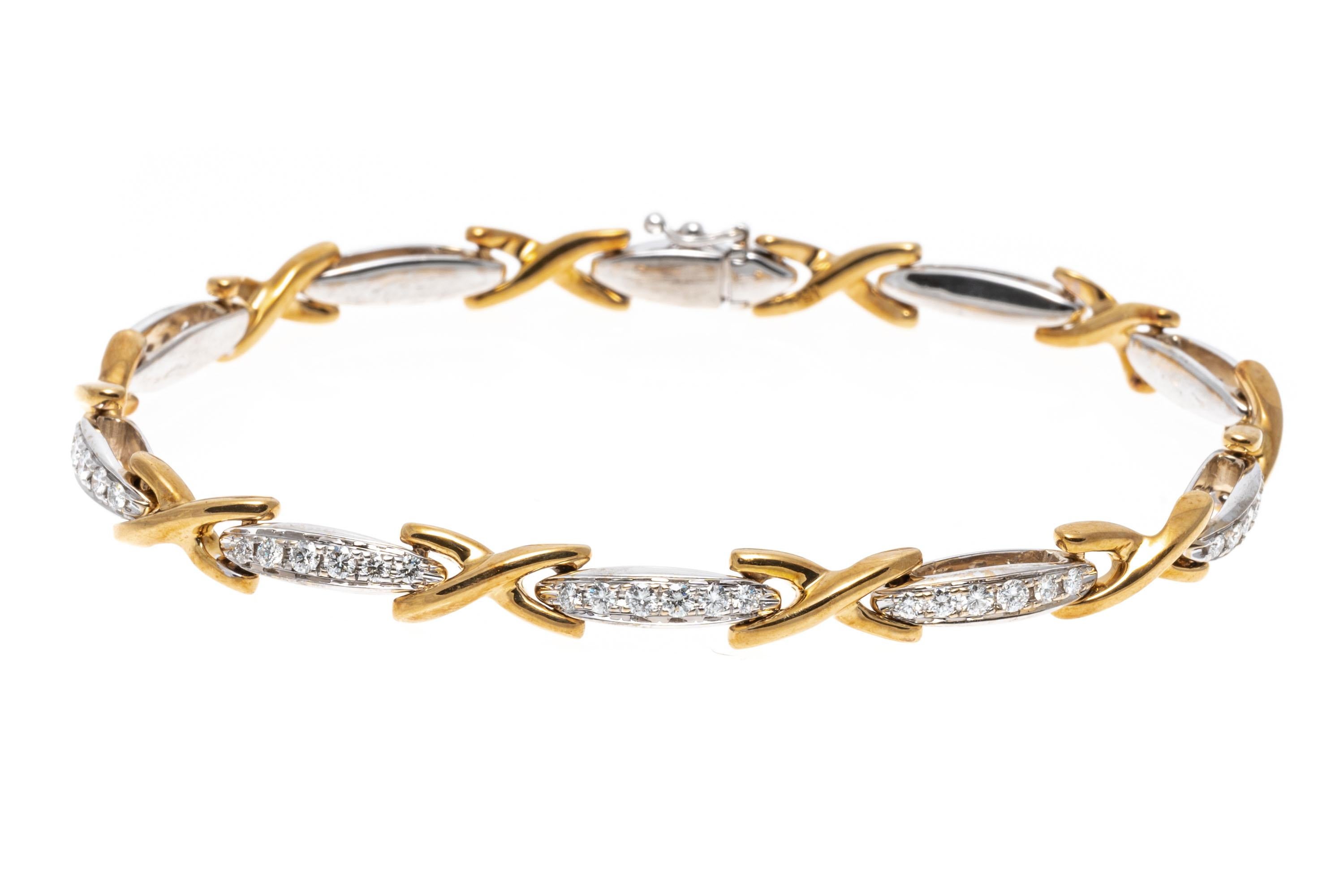 This brilliant line bracelet is crafted from 18K yellow and white gold. The alternating links of this bracelet display yellow gold crosses and white gold bars. The white gold bar links are set with brilliant cut diamonds creating a dazzling shine.