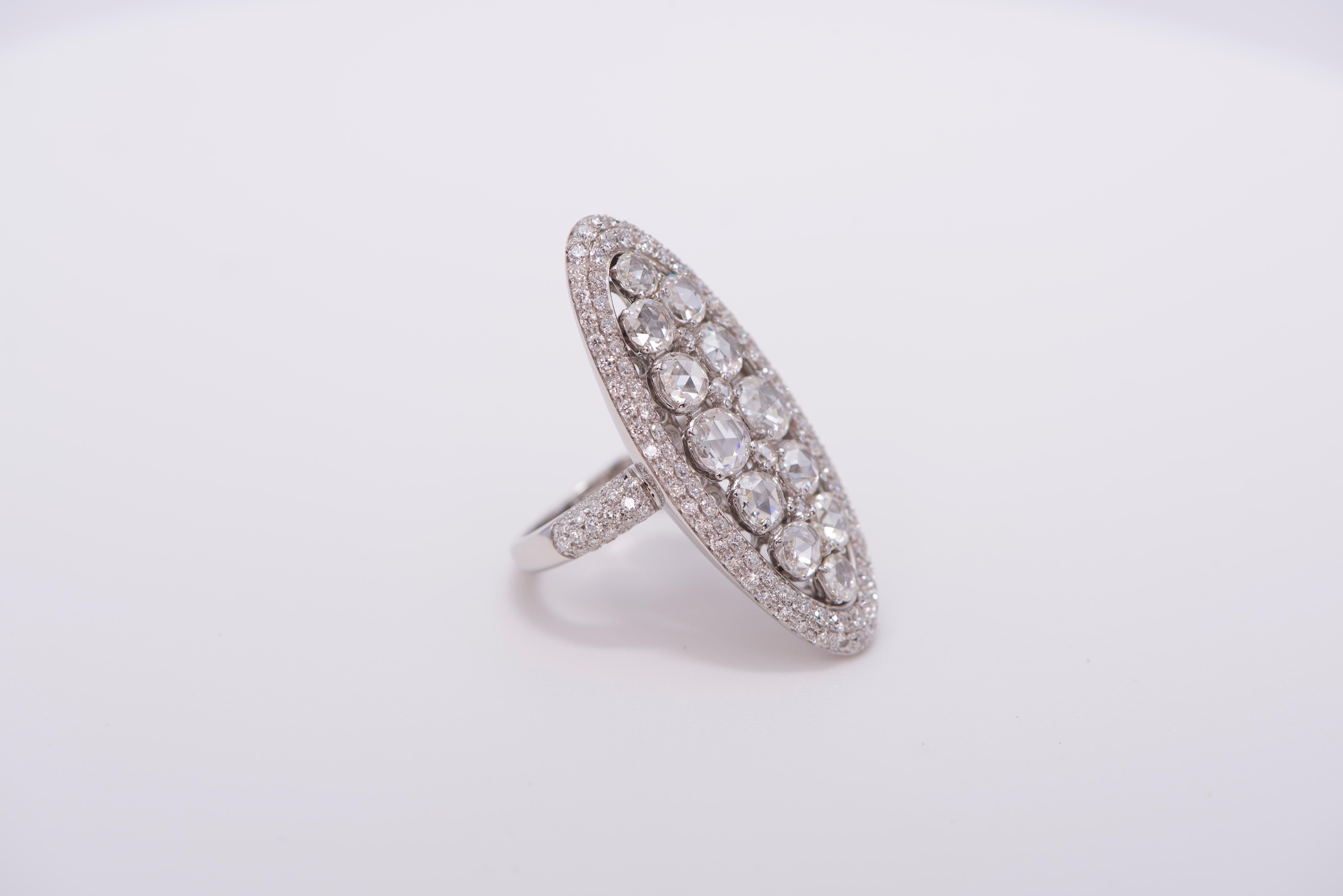 Oval shaped ring in 18K white gold with white diamonds along border, shank, and in center, approx. 3.82 carats of diamonds in total. 