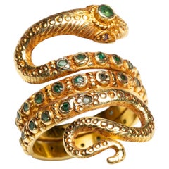 Ring in Form einer gewundenen Schlange aus 18-karätigem Gold und facettierten Smaragden