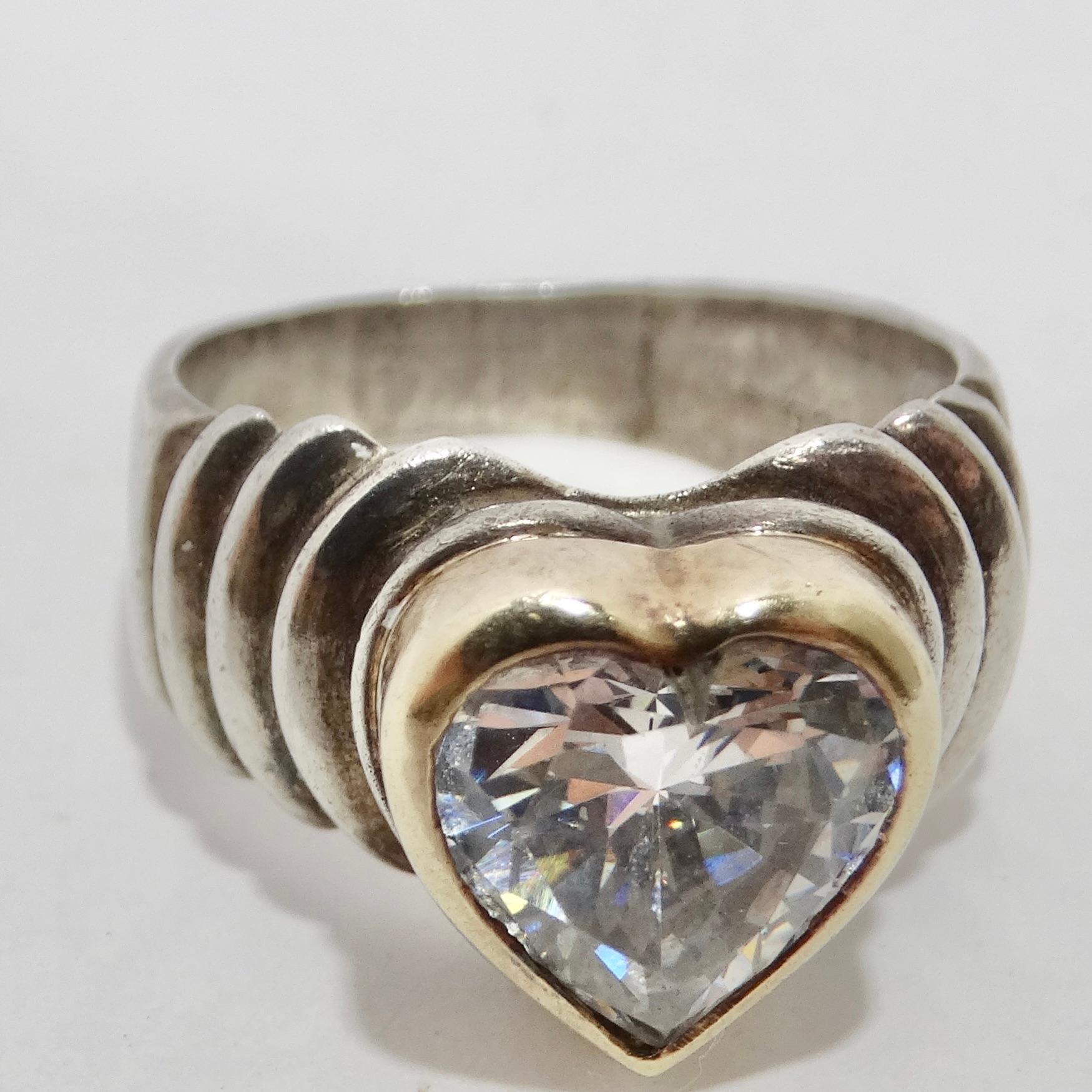 Introducing our 18K Gold and Silver Rhinestone Heart Ring, a symbol of timeless elegance and everlasting love. This exquisite ring merges the beauty of silver and gold with a hint of flirtatious femininity. The silver textured band serves as a