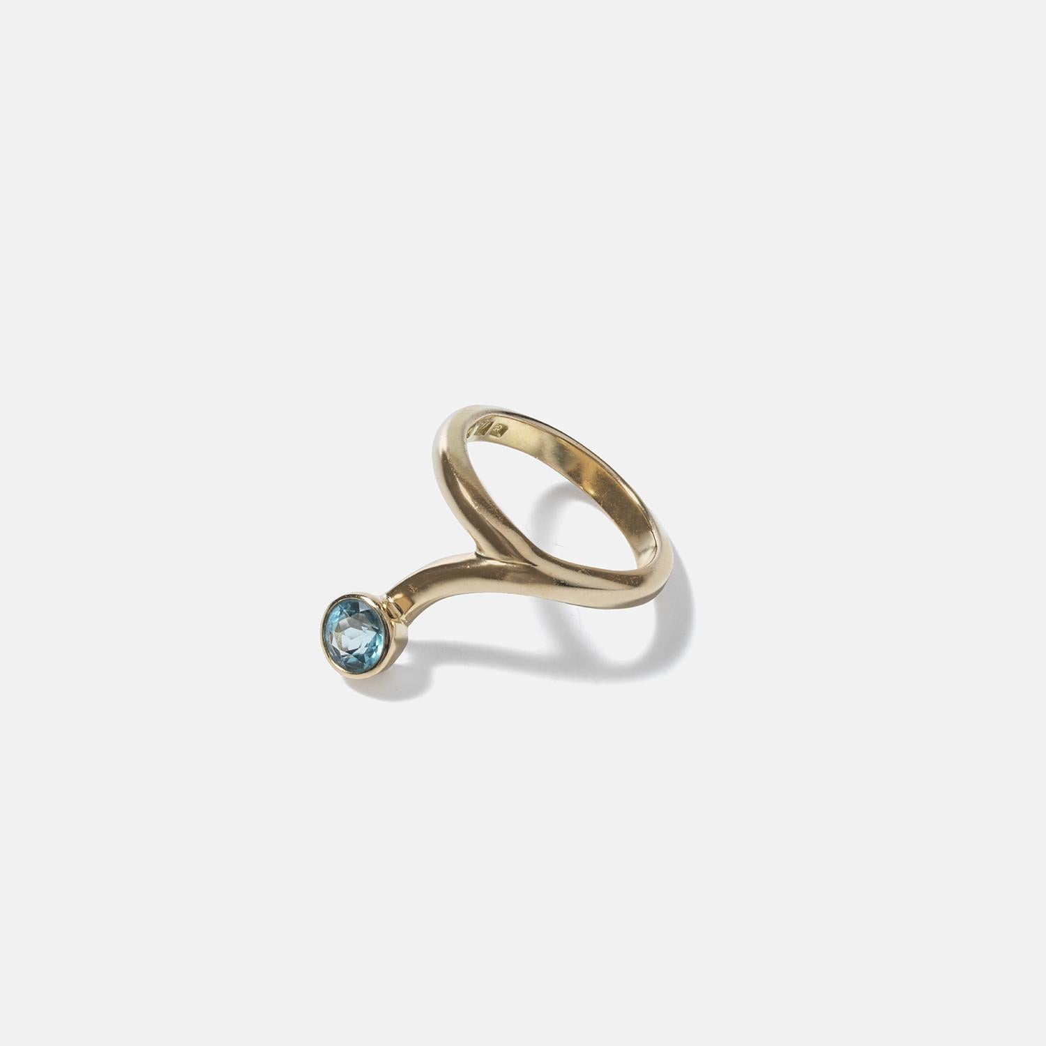 This 18-karat gold ring has a round turquoise stone embedded at the end, adding a vibrant contrast to the gold. The band spirals around the finger in a snake-like manner, giving it an exotic and oriental touch. The gold has a high polish, enhancing