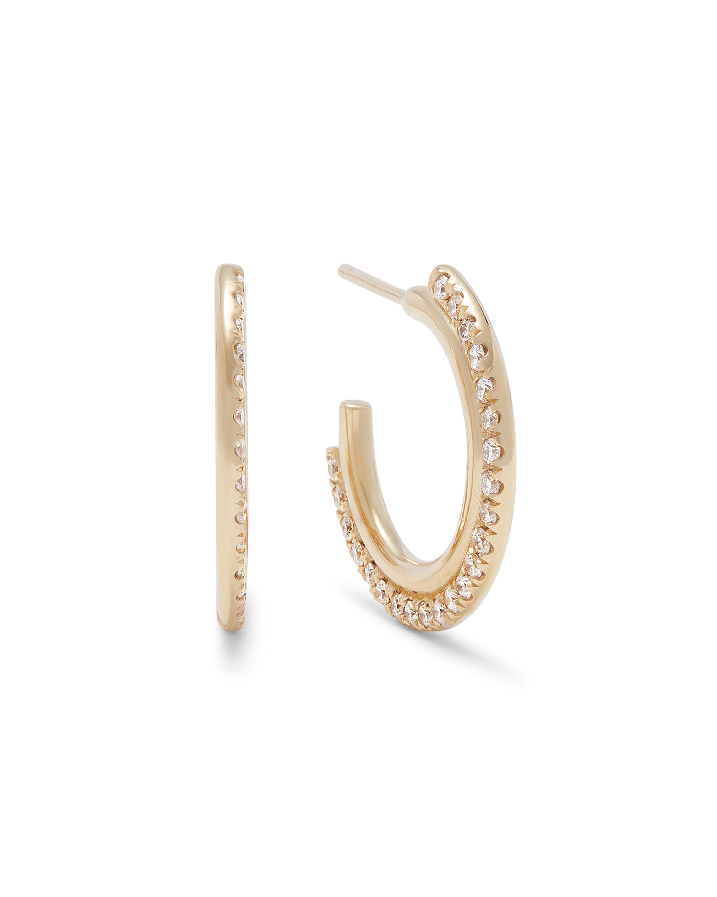 Architectural yet minimal hoop earrings in 18K yellow gold. The hoops feature a rounded band detail set with brilliant cut diamonds. Their petite size makes them ideal for every day wear while adding just the right amount of sparkle. Total diamond