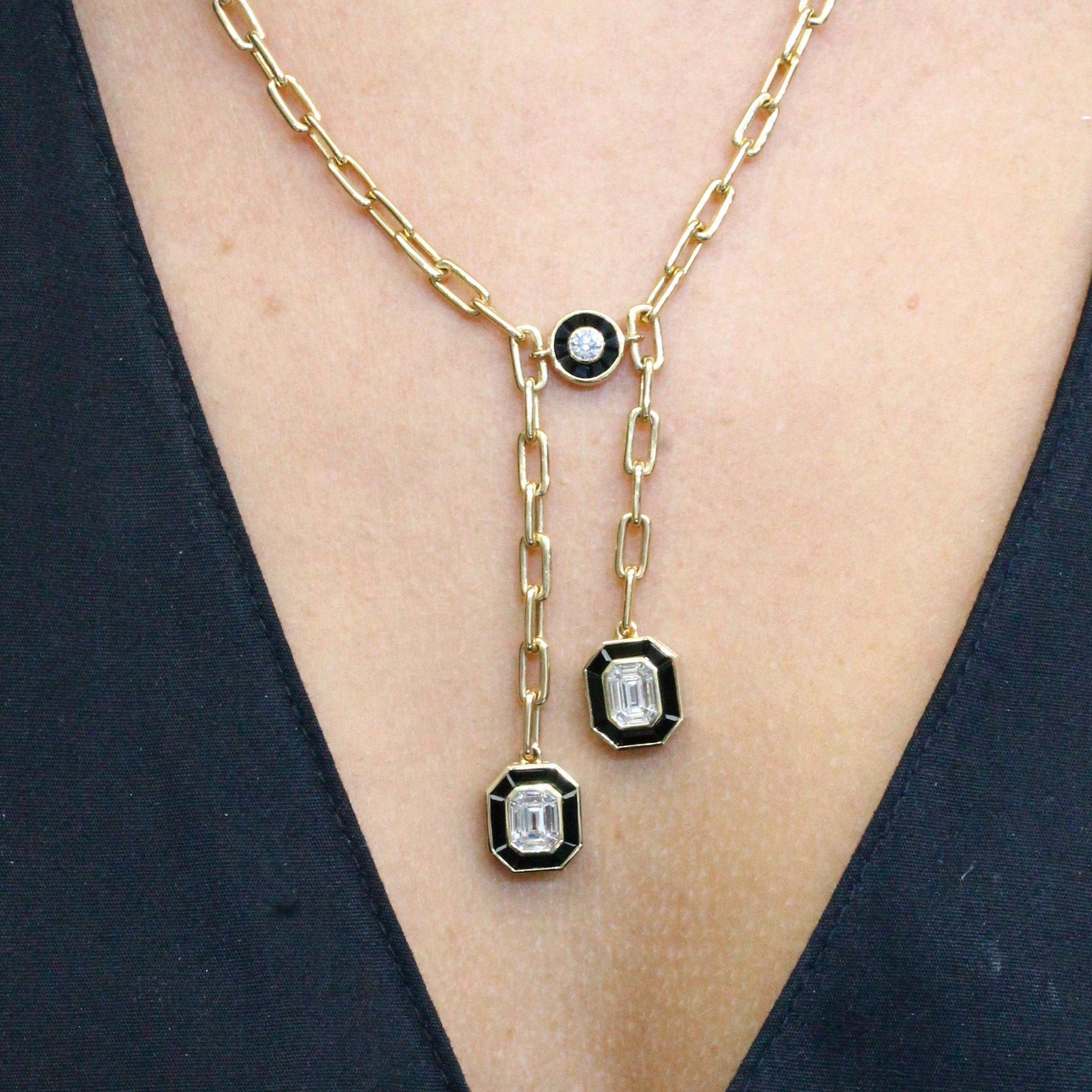 One of a kind show-stopping Lariat Necklace from the Mondrian collection. Featuring (2) Invisible-Set Emerald Diamond Centers made up of Baguettes, as well as a Bezel-Set Round Diamond framed in Black Onyx, in an 18K Yellow Gold Art-Deco setting.