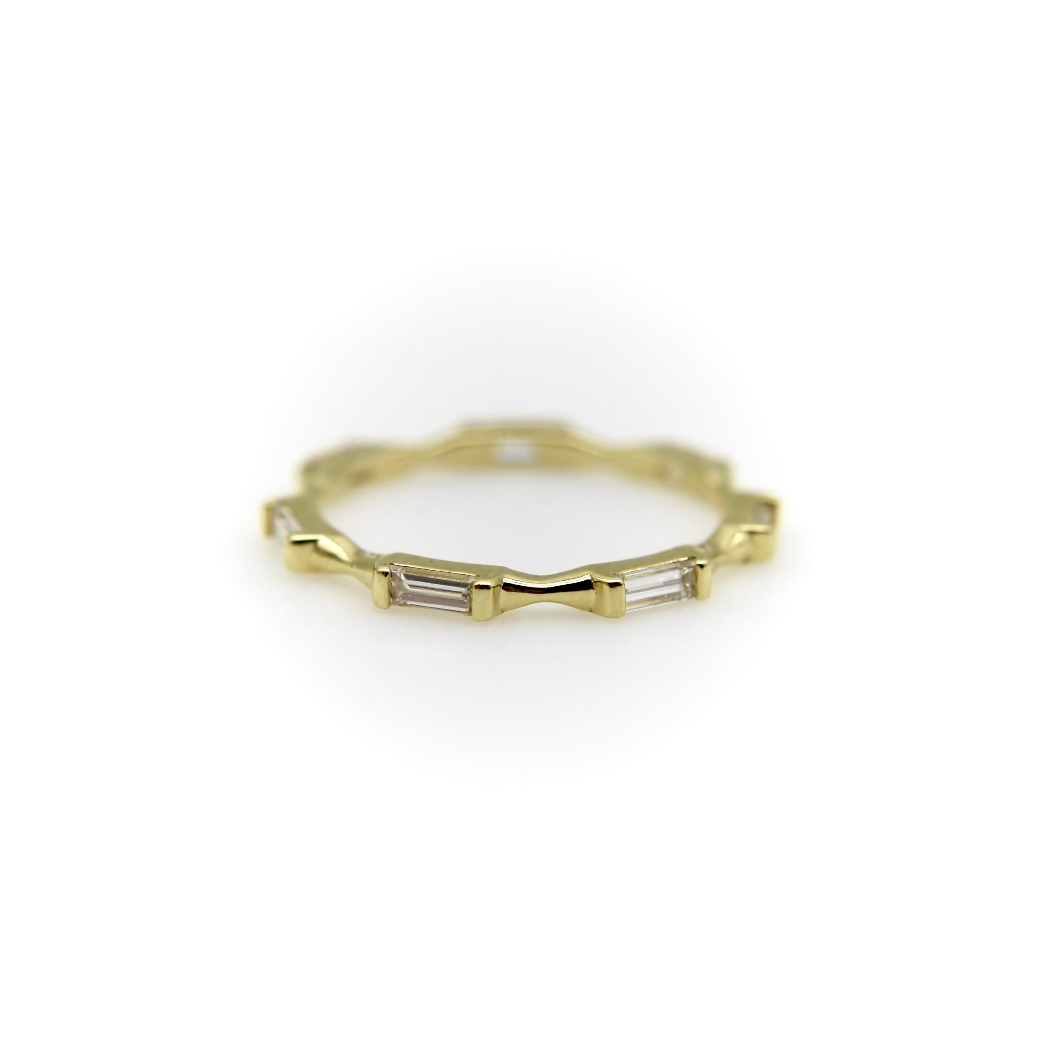 This contemporary take on the classic eternity band is part of Kirsten’s Corner’s signature collection. The ring consists of seven baguette diamonds set horizontally in 18k gold. The band in between each diamond narrows into a cinched, ribbonlike