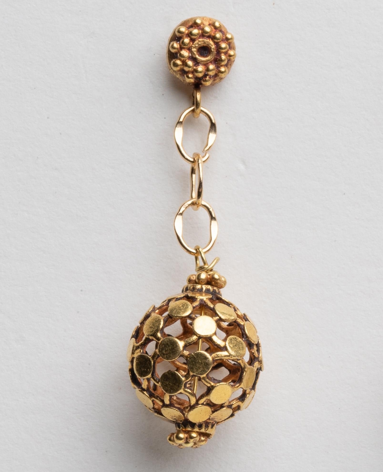 An unusual pair of 18K gold dimpled ball earrings dangling from a gold chain and granulated gold post.  For pierced ears.  By Deborah Lockhart Phillips.