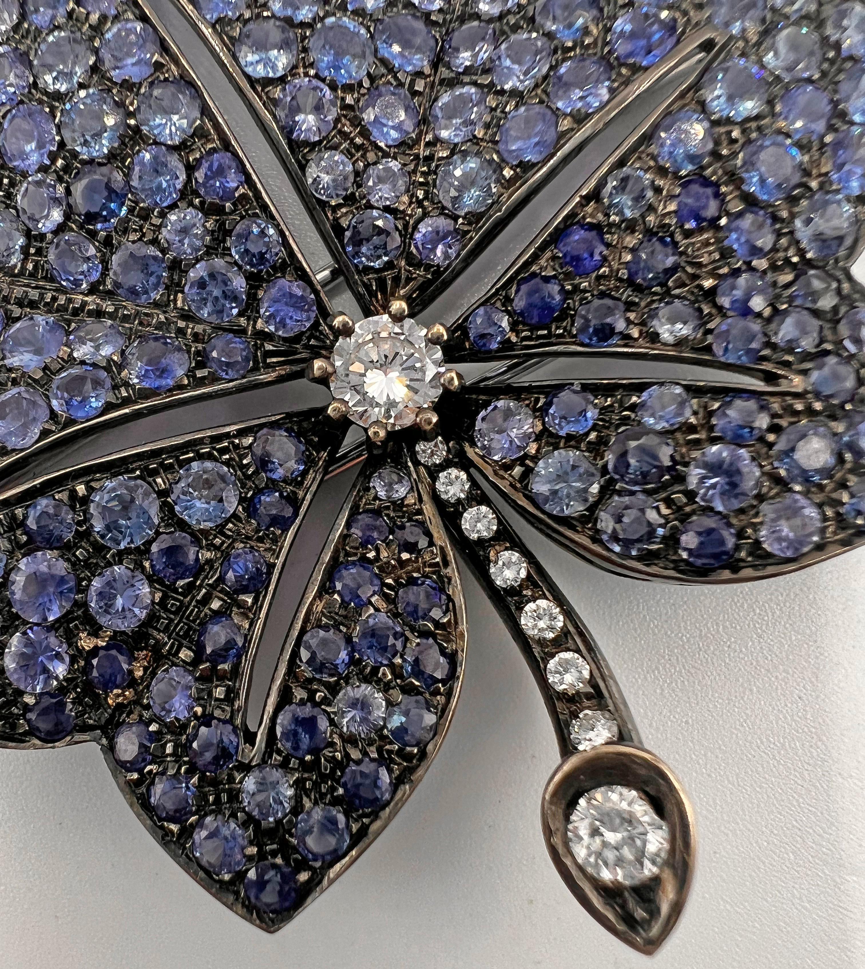 18k gold, vibrant blue sapphire and diamond leaf brooch measuring 2.5