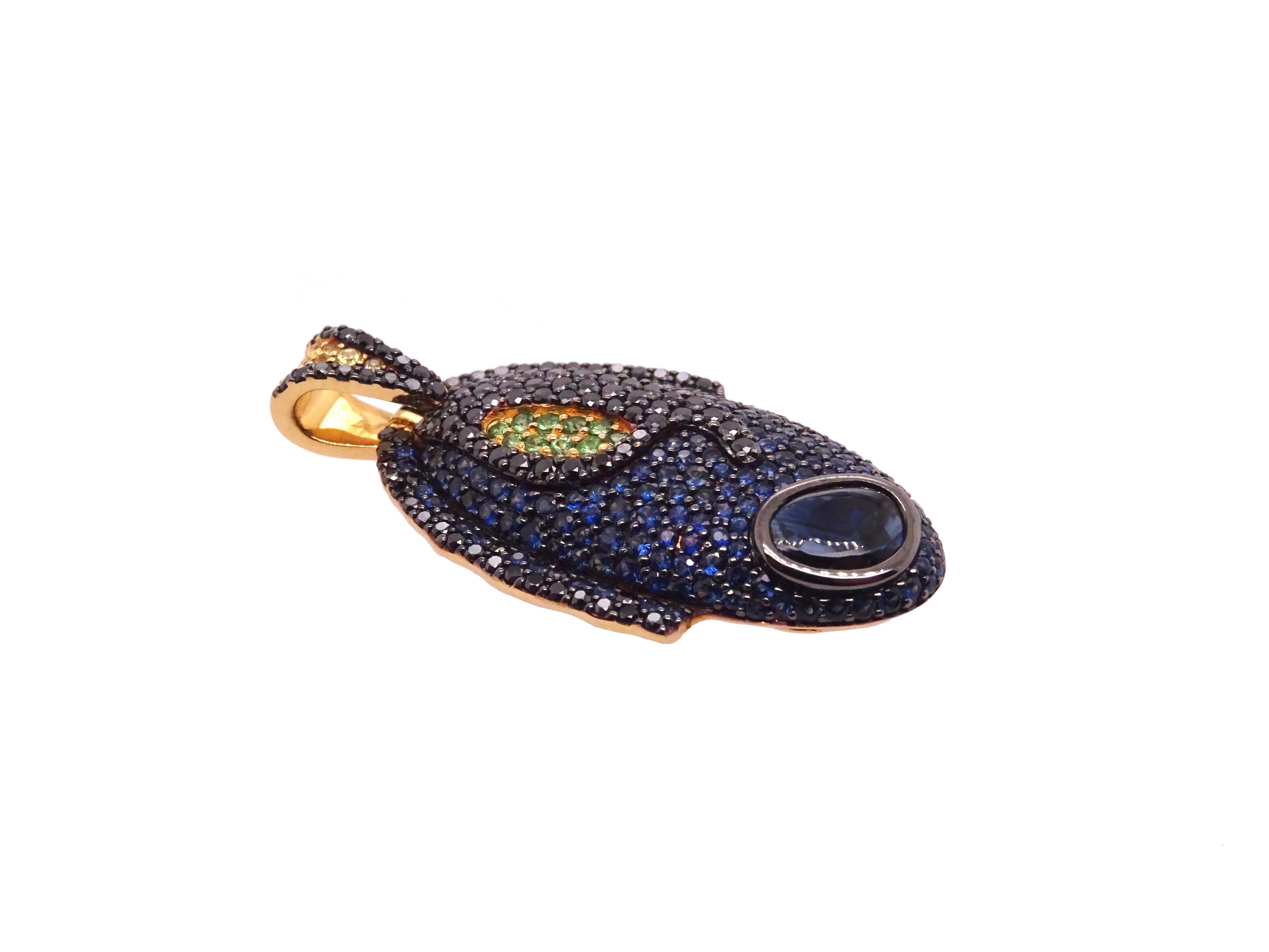 Ocean Dreams collection by VOTIVE.

Immerse yourself in the captivating allure of VOTIVE's Ocean Dreams collection, featuring a striking 18K yellow gold pendant adorned with black diamonds, yellow and blue sapphires, and tsavorites. Inspired by the