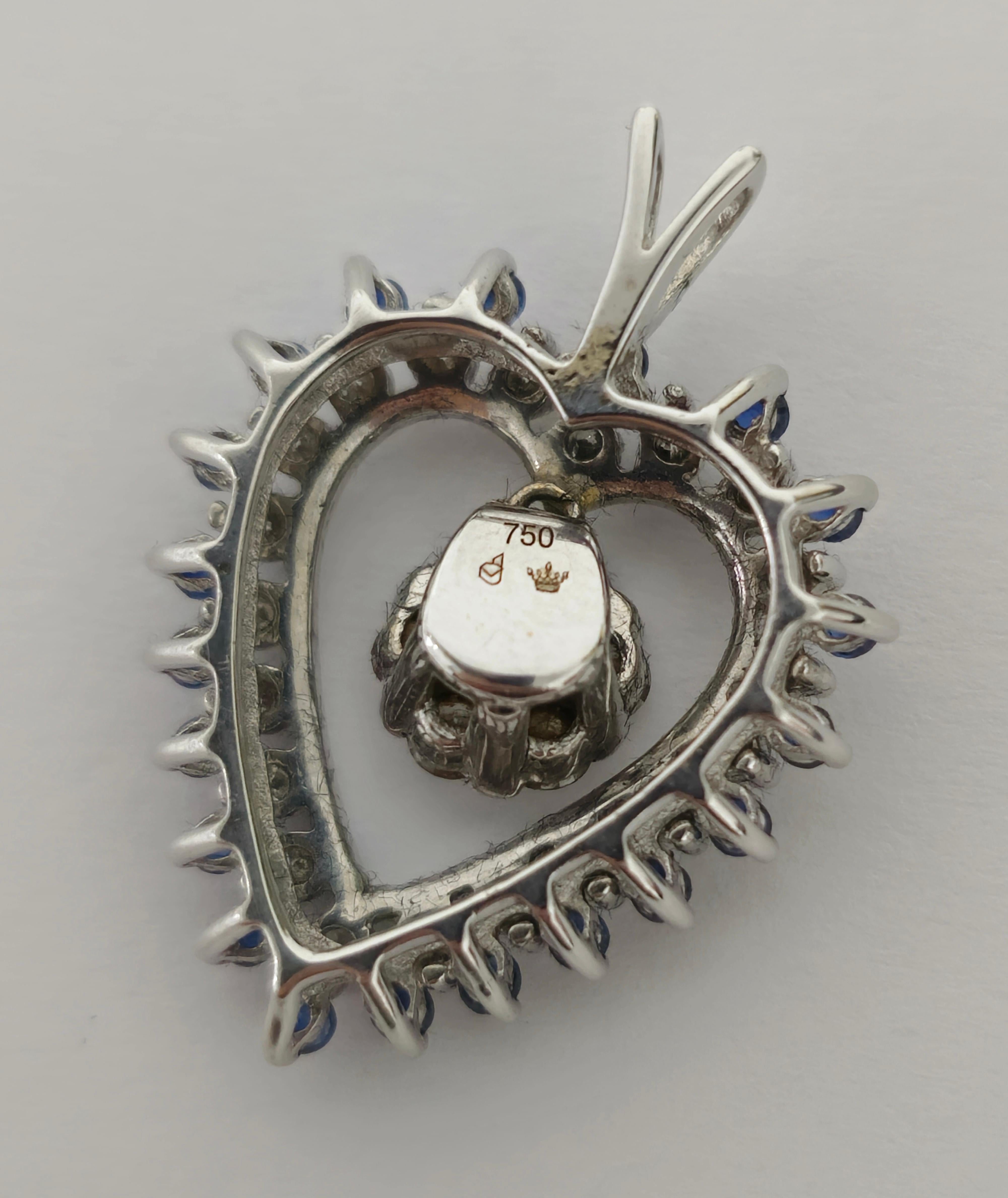 Crafted from 18k white gold, this pendant features a heart-shaped blue sapphire adorned with high-quality round brilliant-cut diamonds. The diamonds boast F color and VS clarity, ensuring exceptional brilliance and sparkle. With its elegant design