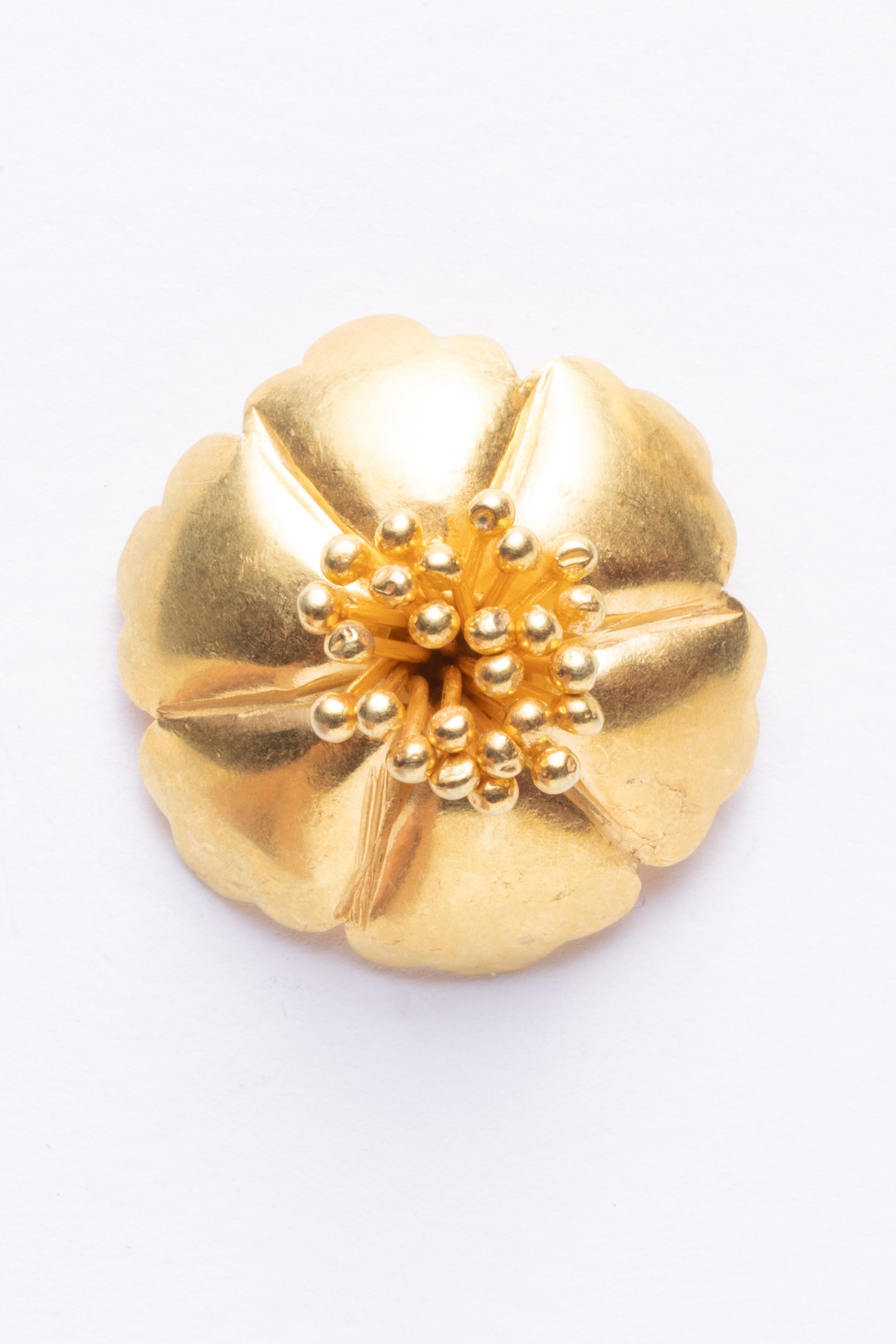A pair of 18K gold button stud earrings in a floral motif.  The center features a cluster of textural and dimensional flower stamens.  18K gold posts for pierced ears.