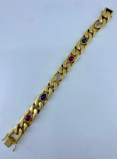 Armband aus 18 Karat Gold mit Cabochon-Saphir, Mondstein und Rubin