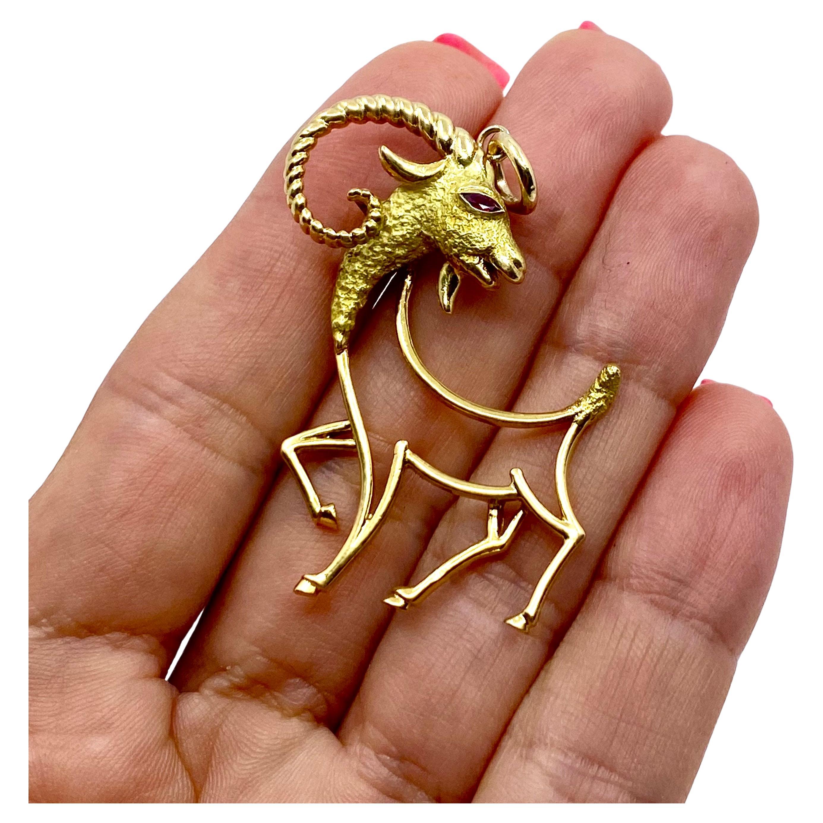 
A graceful 18k gold Capricorn pendant made of 18k gold, featuring ruby. This vintage pendant is crafted in the form of an openwork ibex silhouette. The head is beautifully made of textured gold with the swirled, polished gold horns. The eye