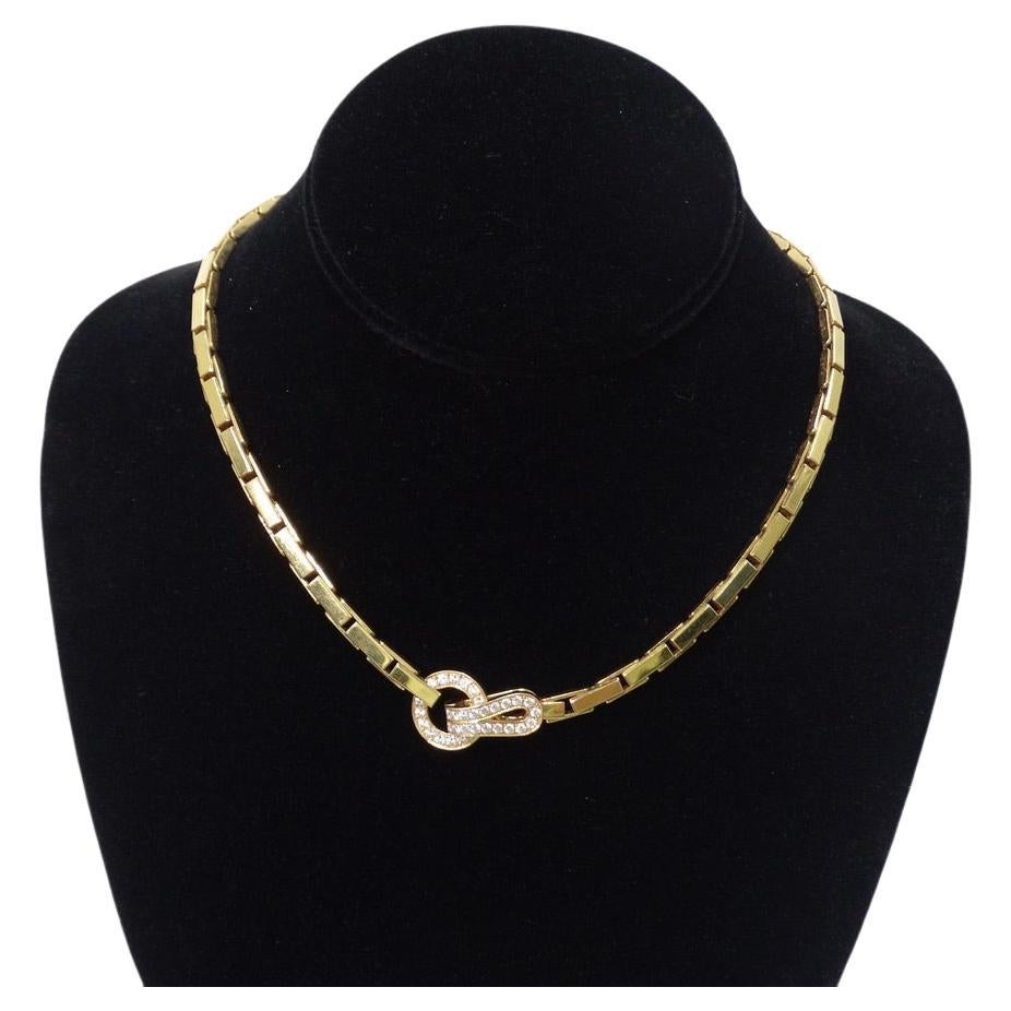  Timeless and elegant an a Agrafe Cartier necklace! Pristine 18K solid yellow gold chain links are offset by a signature Cartier knot style motif encrusted by 34 diamonds. In a classic choker style, this lays so elegantly on the neck and is the