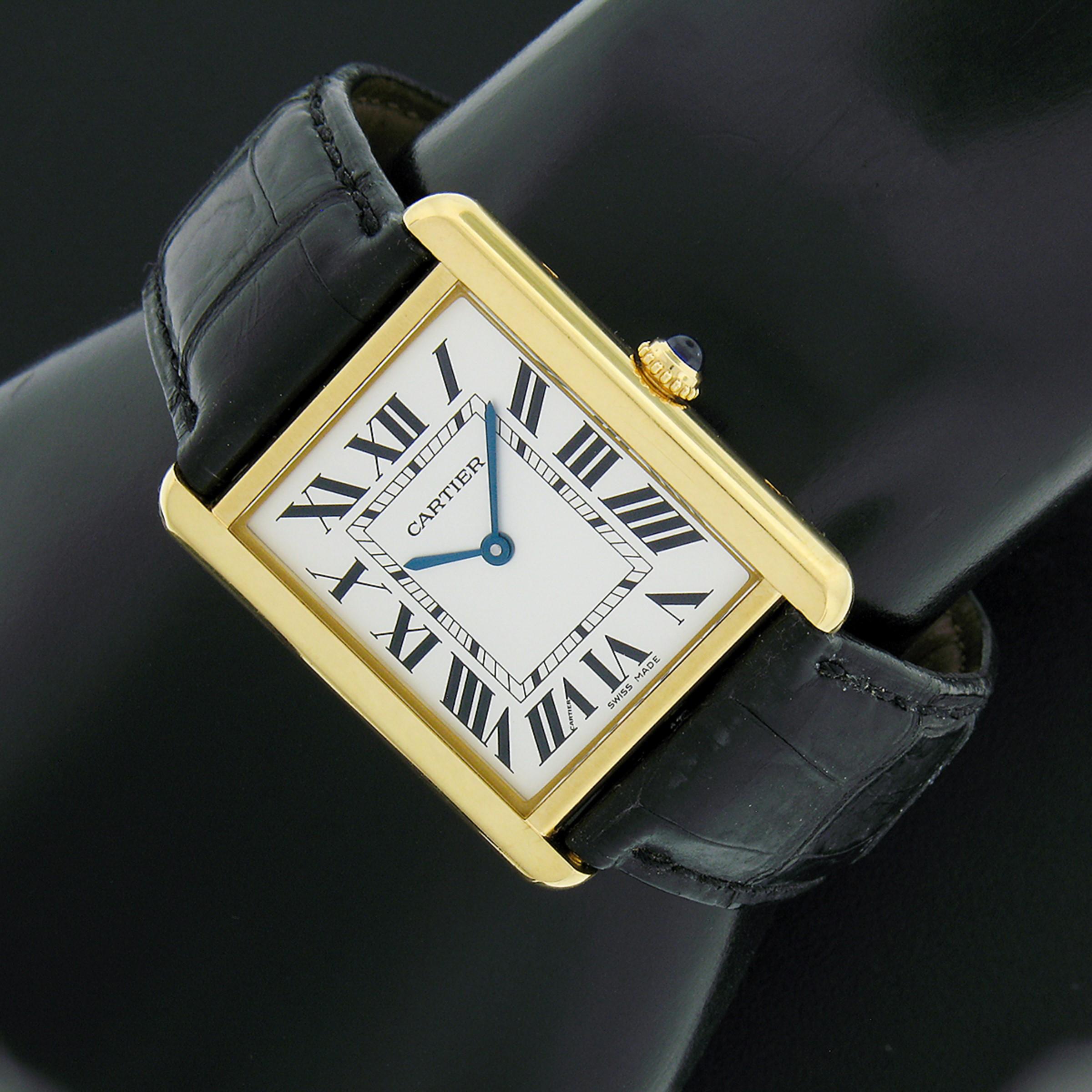 Here we have a gorgeous, 100% authentic, Cartier Tank Solo wrist watch. The case was crafted from solid 18k yellow gold with a stainless steel backing. This watch features a Swiss-made quartz movement which keeps accurate time. The silver-tone black