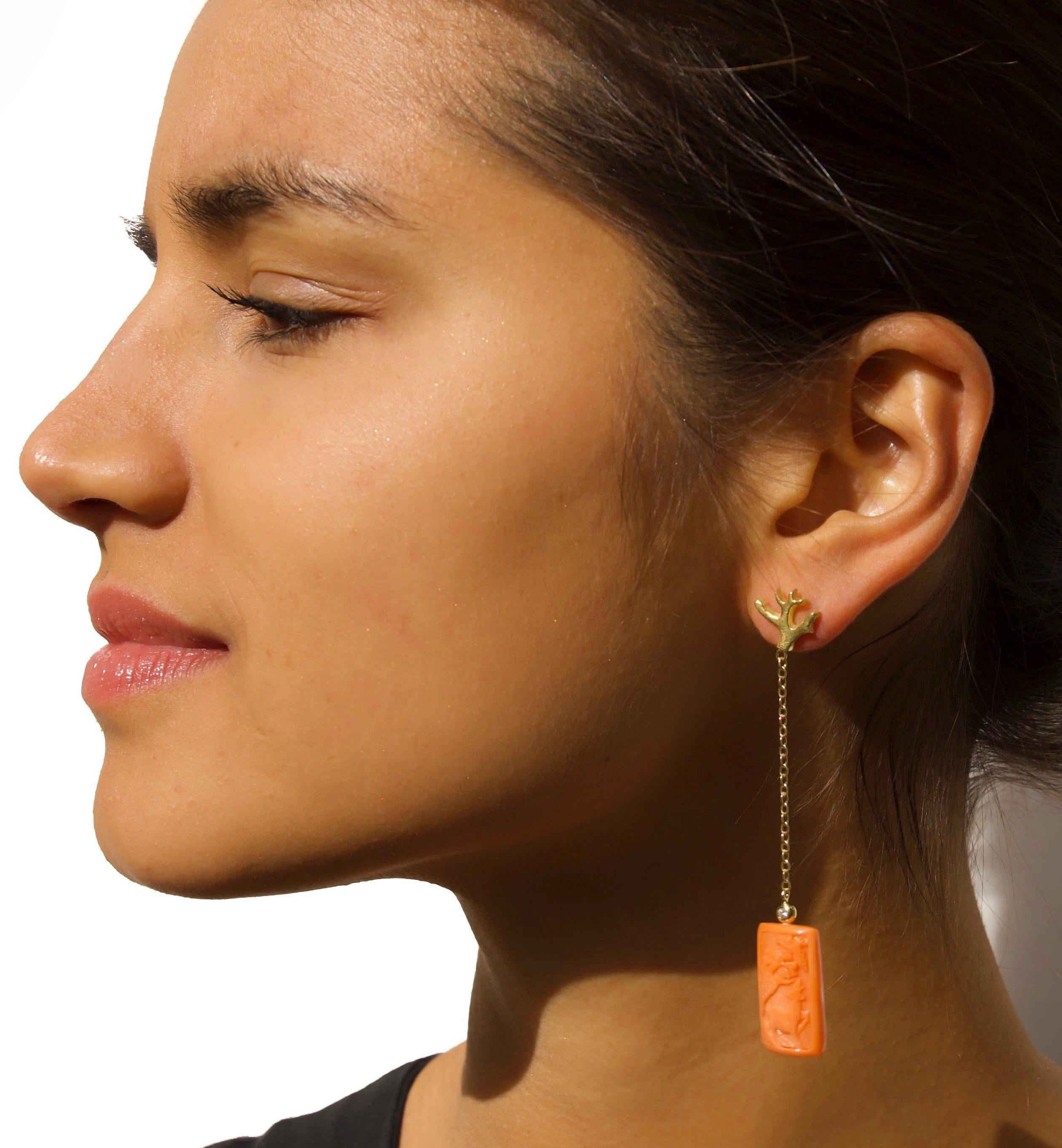 This stunning pair of 18K gold hand-carved coral and diamond earrings is literally one of a kind. An intricate pattern was carved by Italian craftsmen in the coral using skills that have been passed down from generation to generation. The coral is