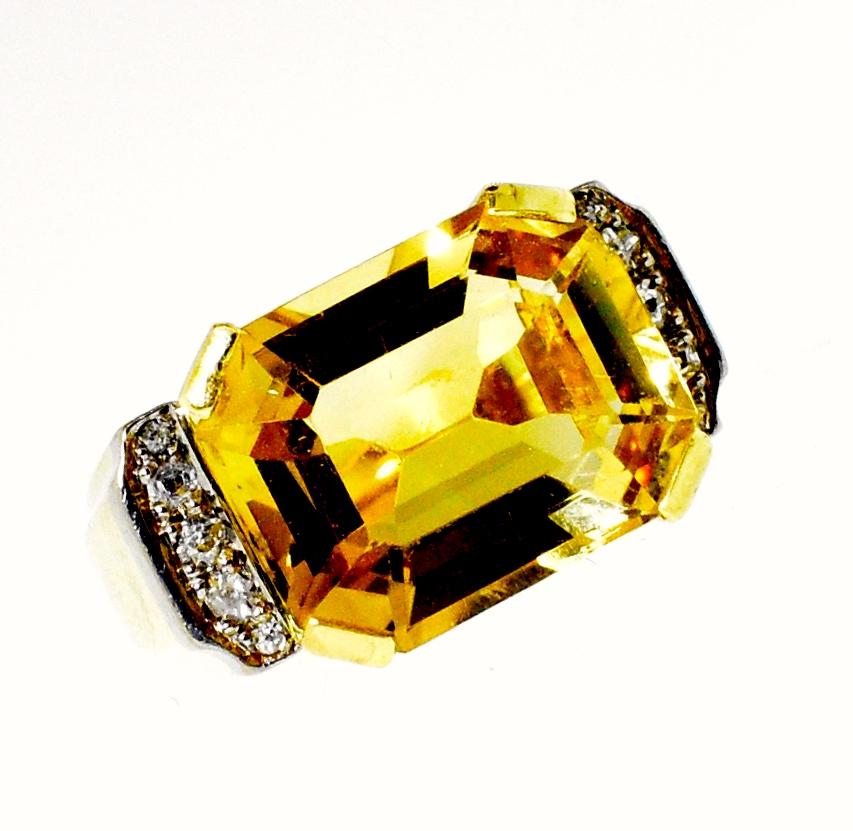 Retro style 18K gold ring centering a fine bright natural citrine accented by small diamonds on both sides.  The citrine weighs approximately 6 cts. and is a size 6.  In fine condition, this ring weighs 12.12 grams.  European circa 1950.