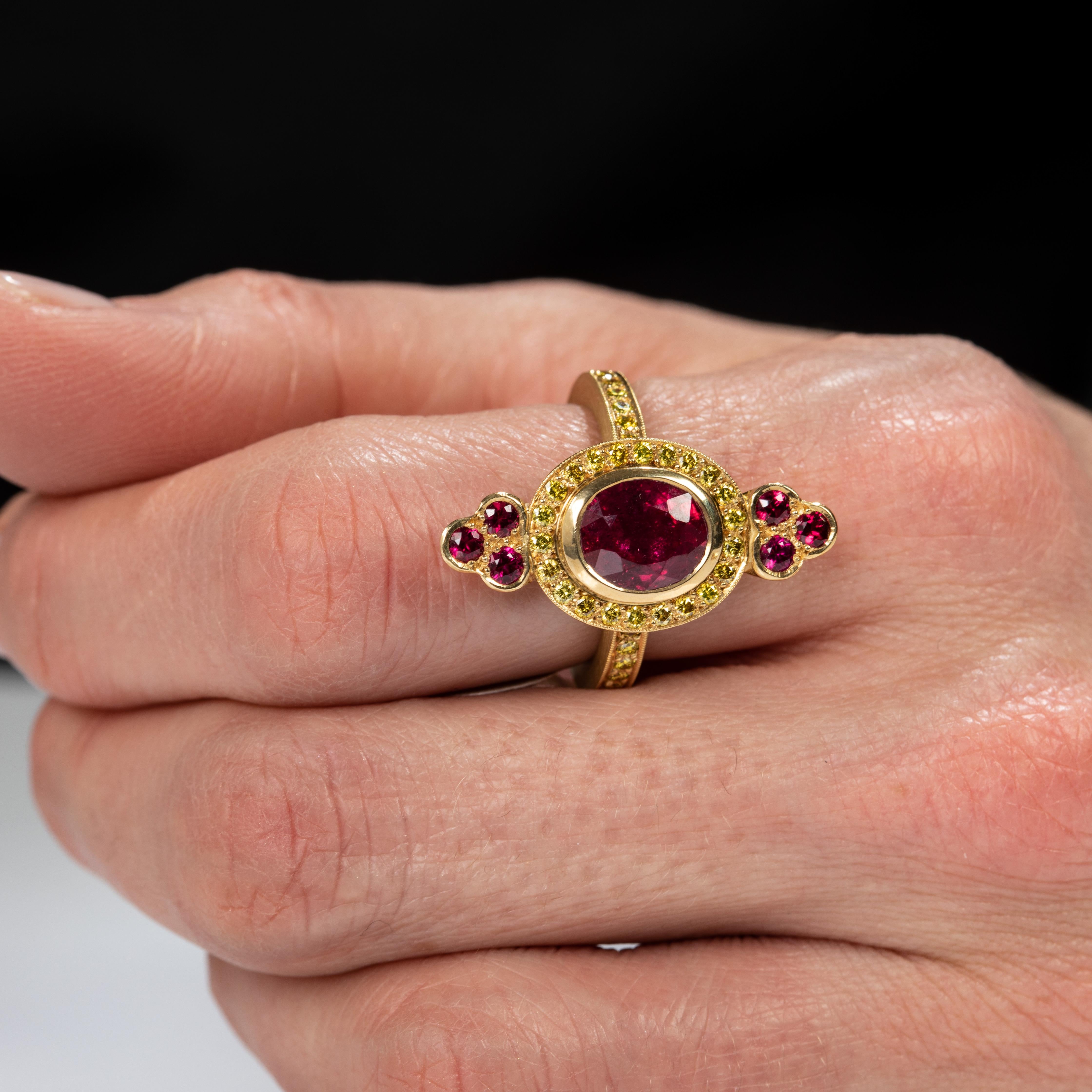 Feel like a diva in this one of a kind creation. A thin 18k yellow gold band, adorned with yellow accent diamonds is the gate way to the real gem - a bezel set Madagascar ruby, surrounded by a crown of sparkling yellow diamonds, and flanked by a