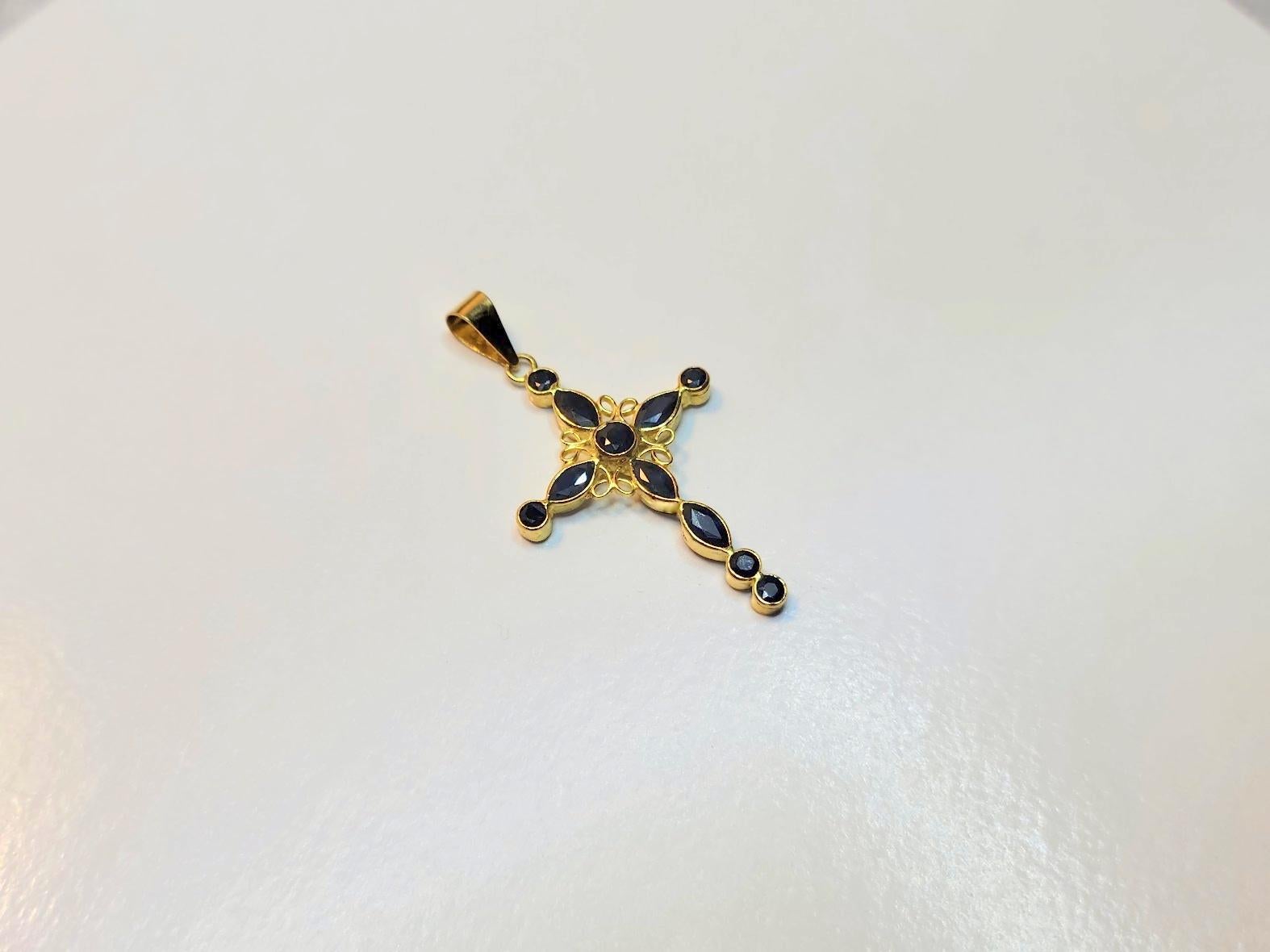 Stunning gold cross pendant with 11 blue sapphires.
Marked with 750 gold or 18 Karat.
Five faceted round sapphire cabochons. The size of one cabochon is 1.5 mm (0.018 carats)
One faceted round sapphire cabochon size - 2 mm (0.04 carats)
Five