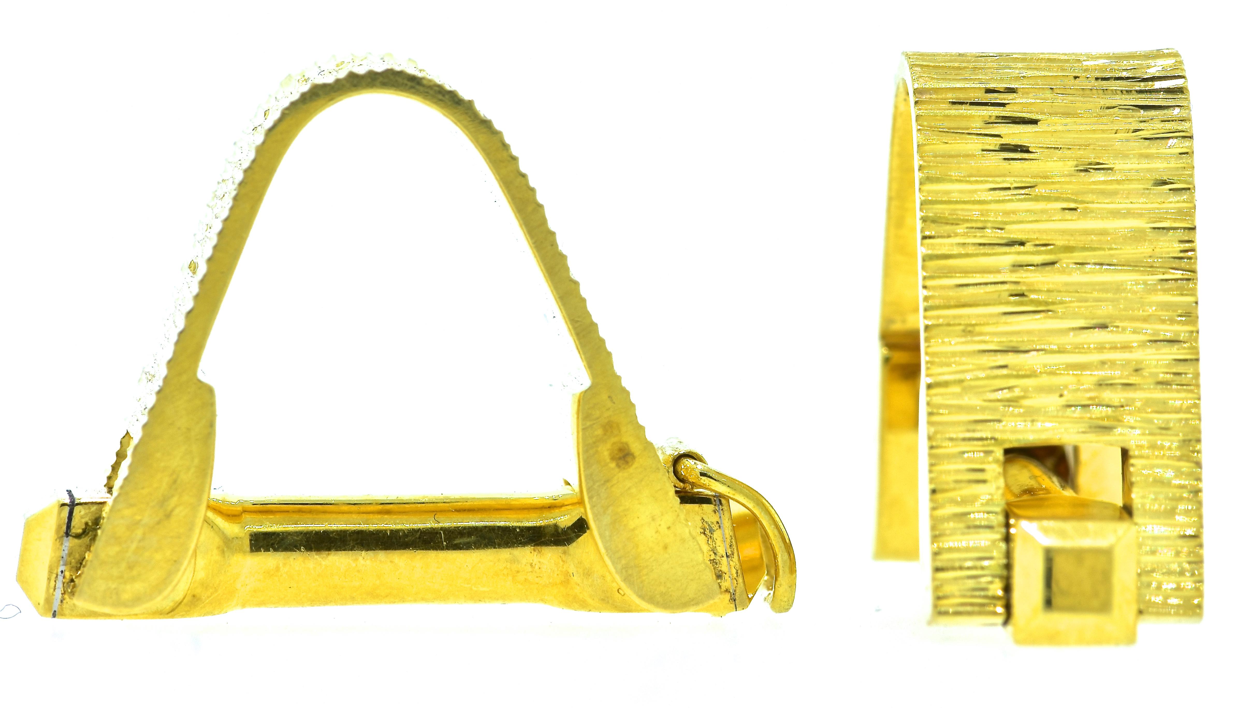 18K yellow gold cufflinks made mid-20th century.  Stirrup style, these cufflinks are well made with fine engineering.  With a locking mechanism, these cufflinks are easy to get on and off.  They weigh 18.43 grams of 18k yellow gold.