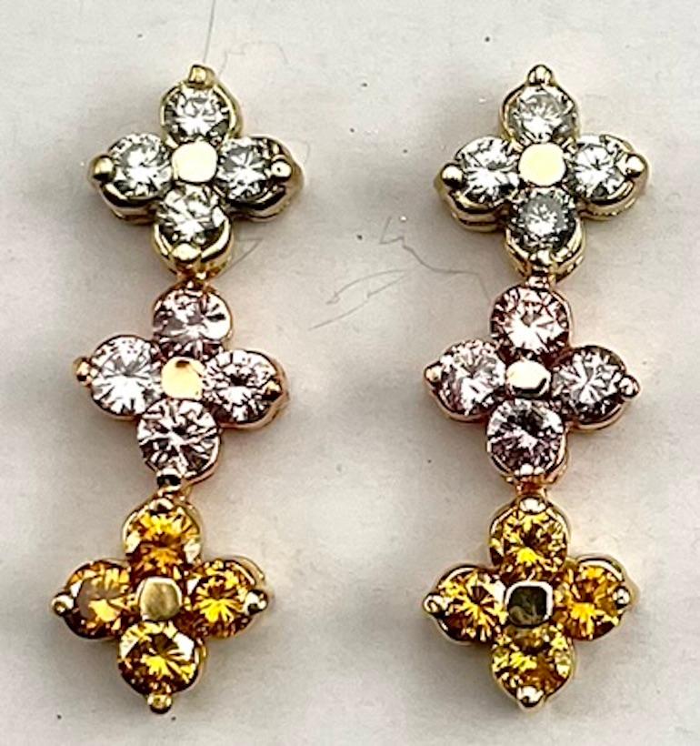 These earrings feature a unique combination of Round Natural Color Diamonds in the shade of Greenish, Pink, And Orangey Yellow. The earrings sit very well and very comfortably on the ear and the combination of color catches the light beautifully.