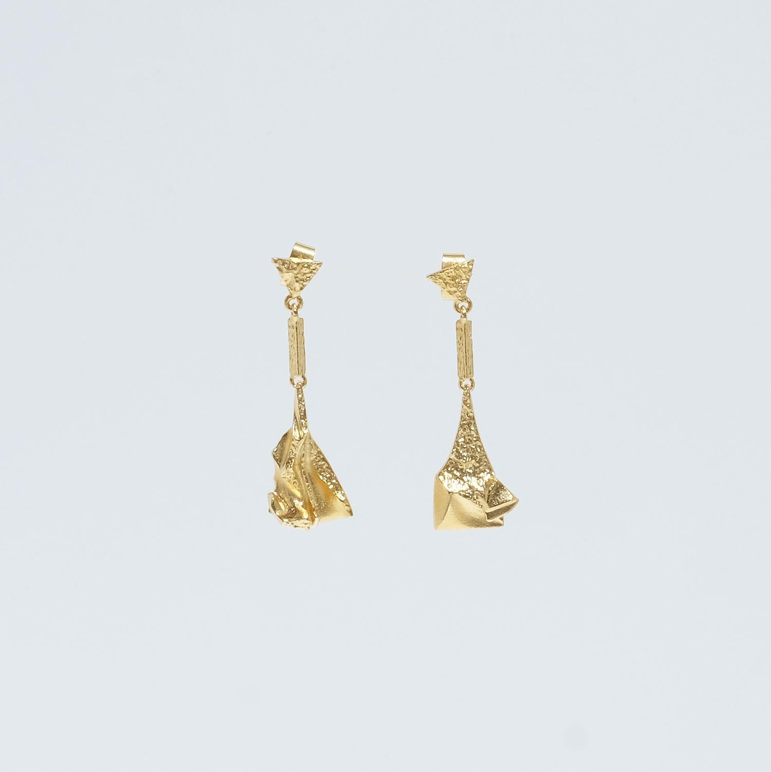 These 18 karat gold earrings are called Scarlett. They show upon typical Björn Weckström design characteristics with the shimmering matte gold, the broken and uneven surfaces in combination with the simple, sculptural qualities. To keep the earrings
